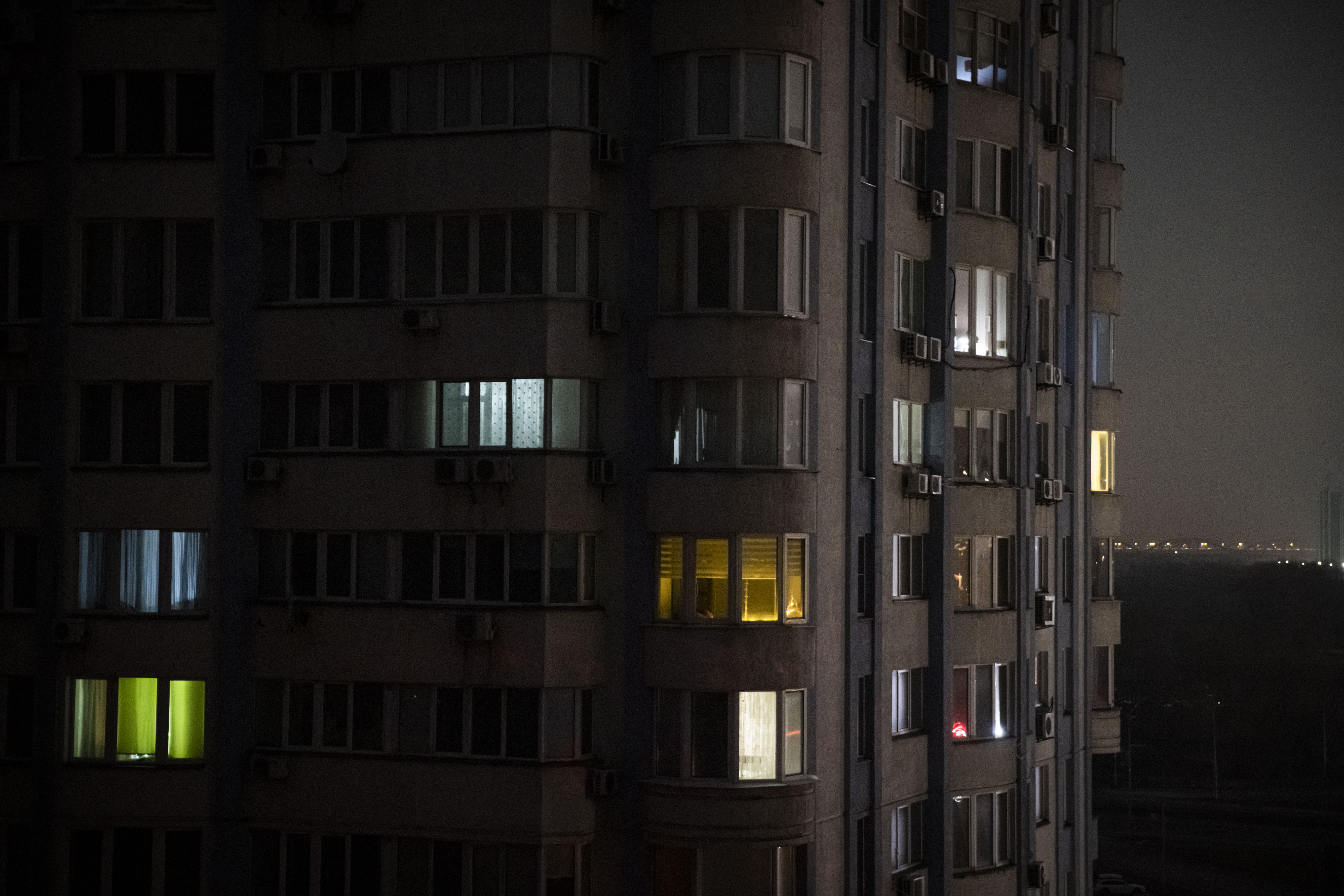 Apartment blocks stand in near total darkness