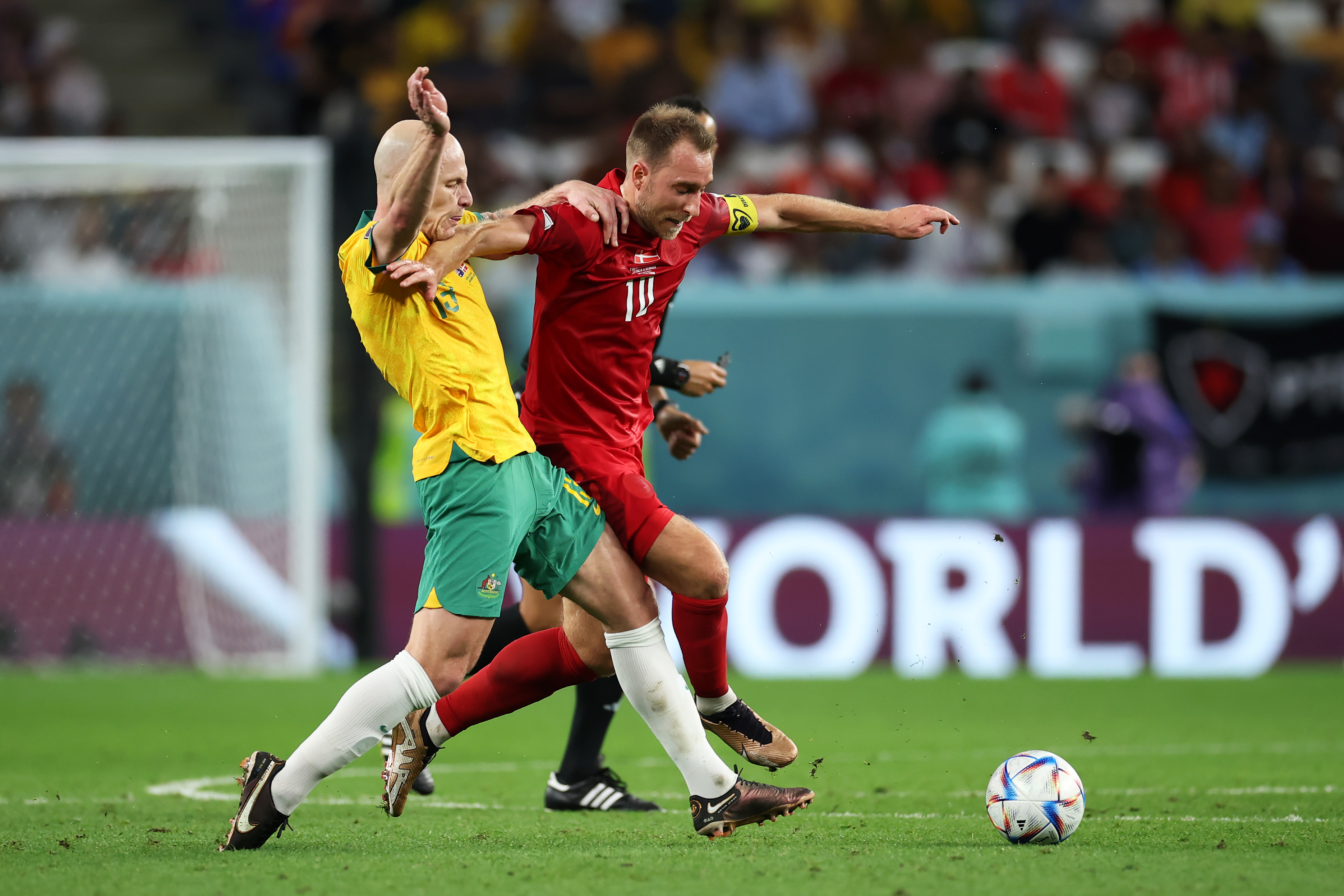 hristian Eriksen of Denmark battles for possession with Aaron Mooy of Australia