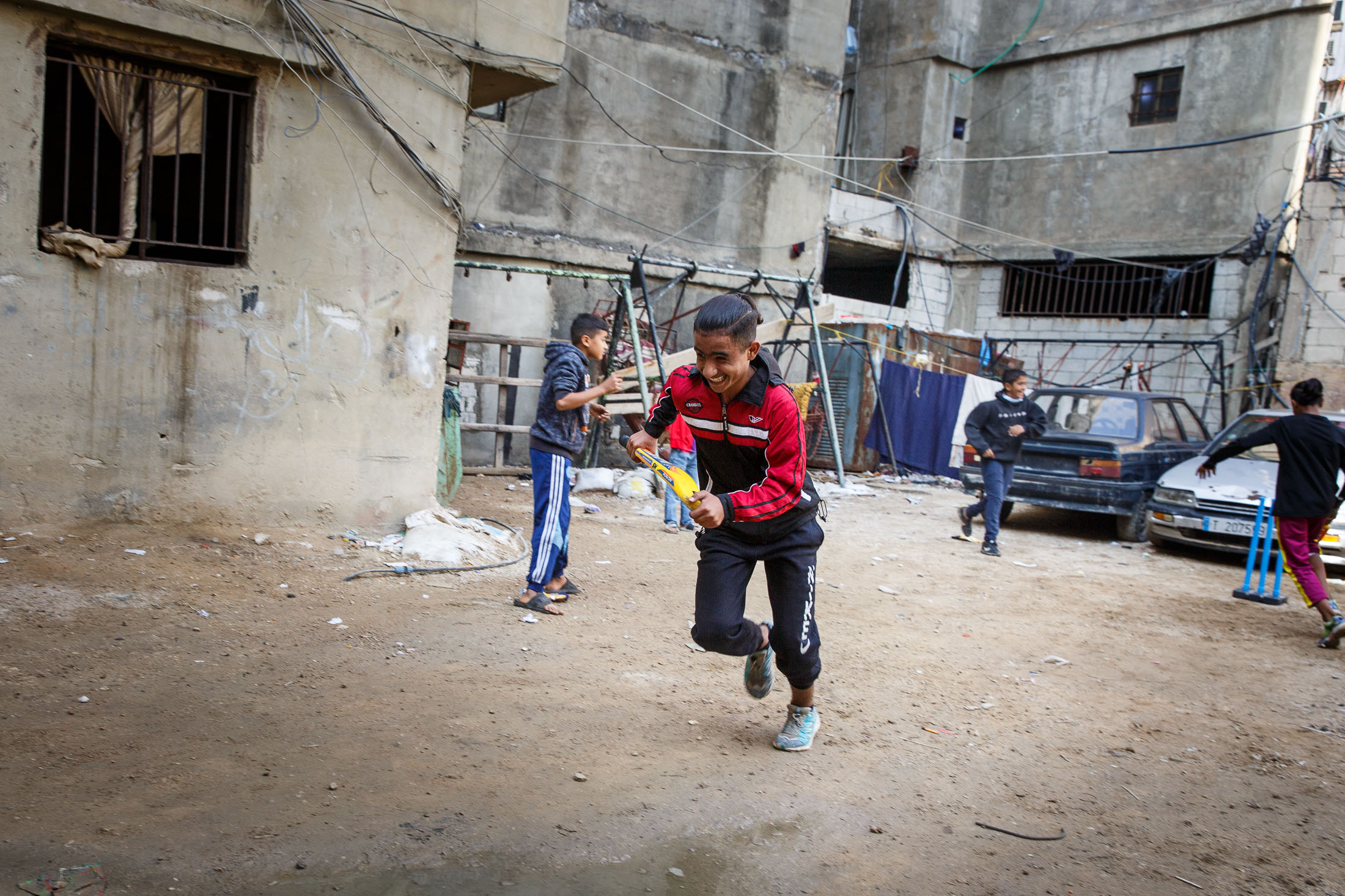 Child running while playing cricket 