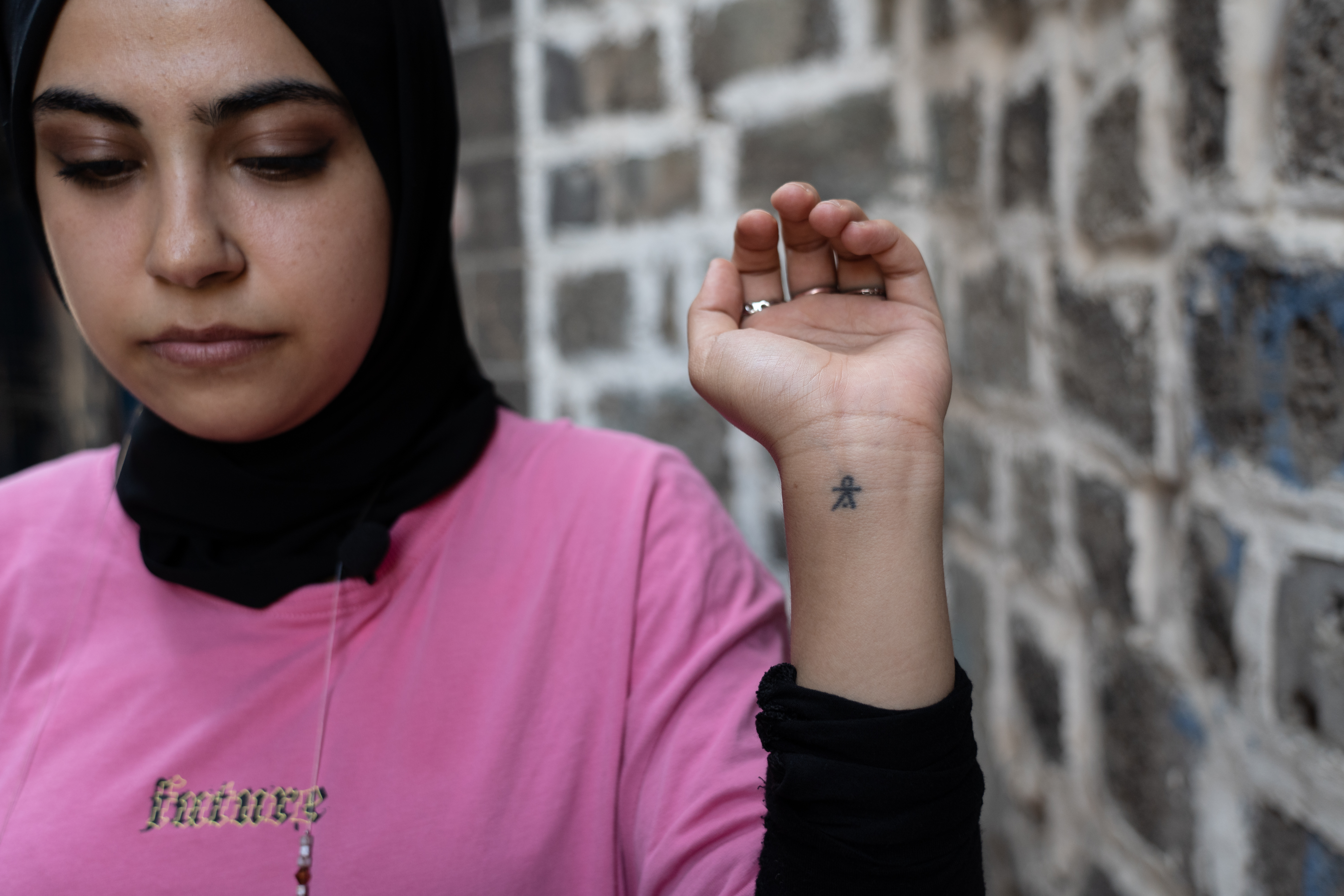 A young woman with a deq tattoo