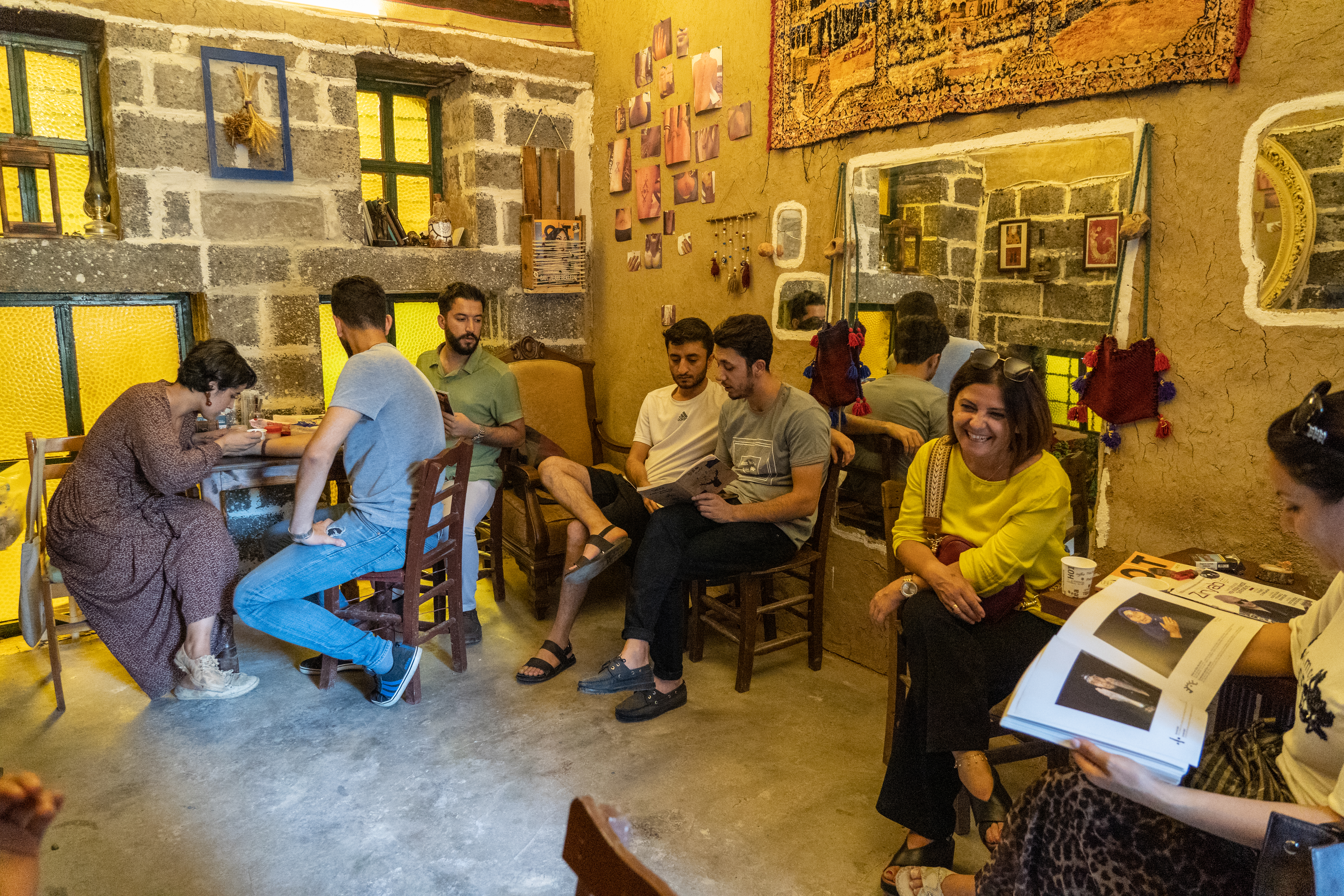 A photo of customers lining up inside Temel’s studio, waiting for their turn to receive their own deq motifs.