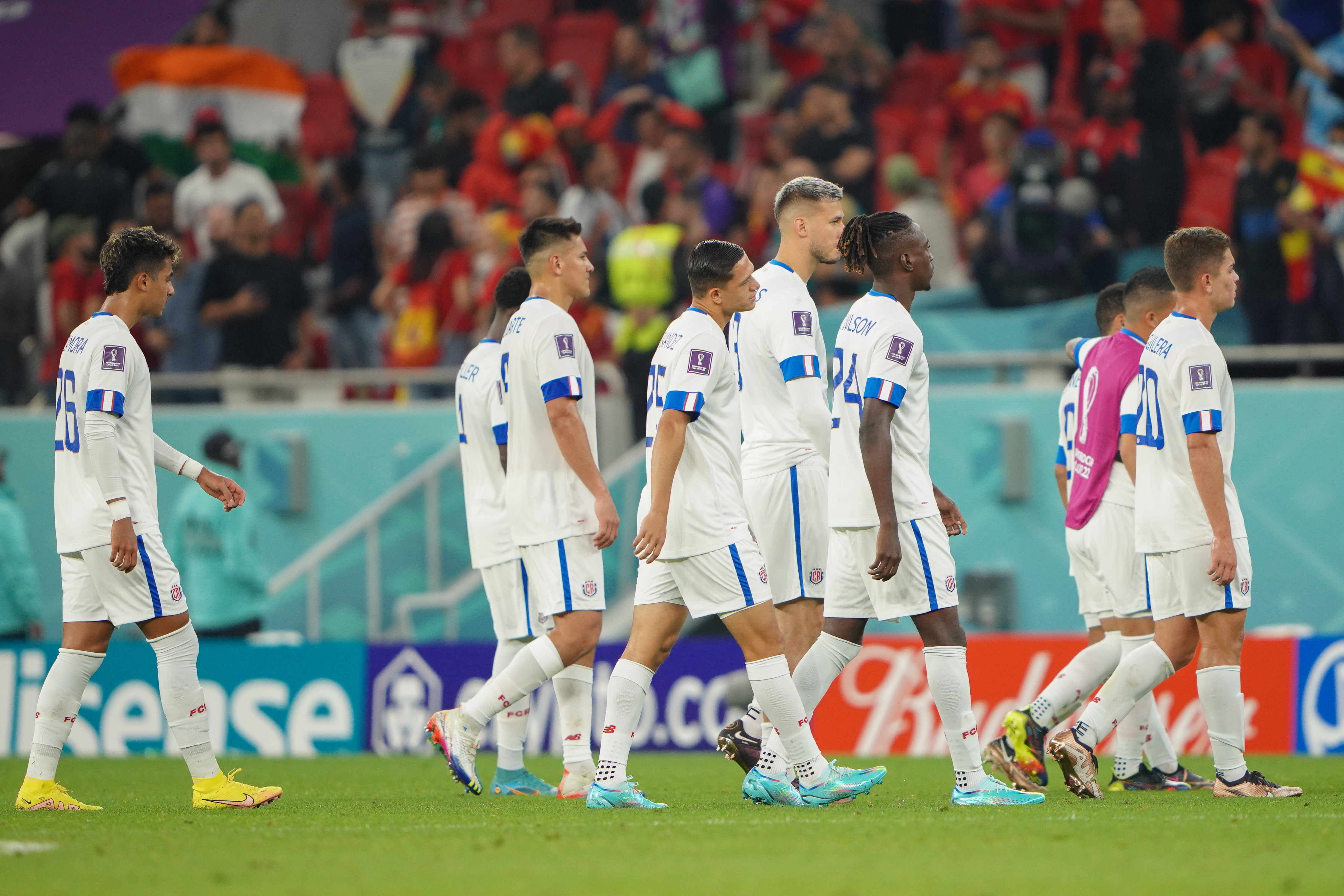 Costa Rica team strolling across the field, from the side