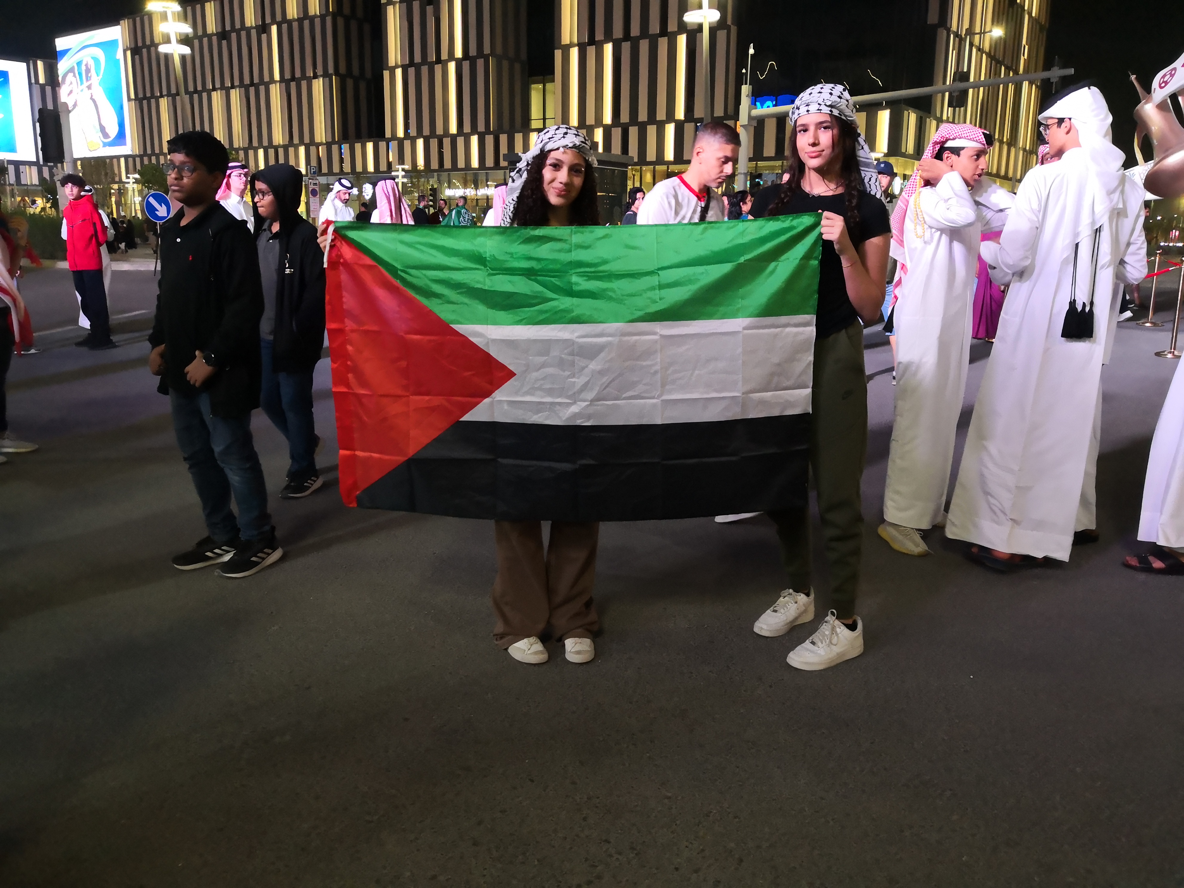 Two women hold up a Palestinian flag