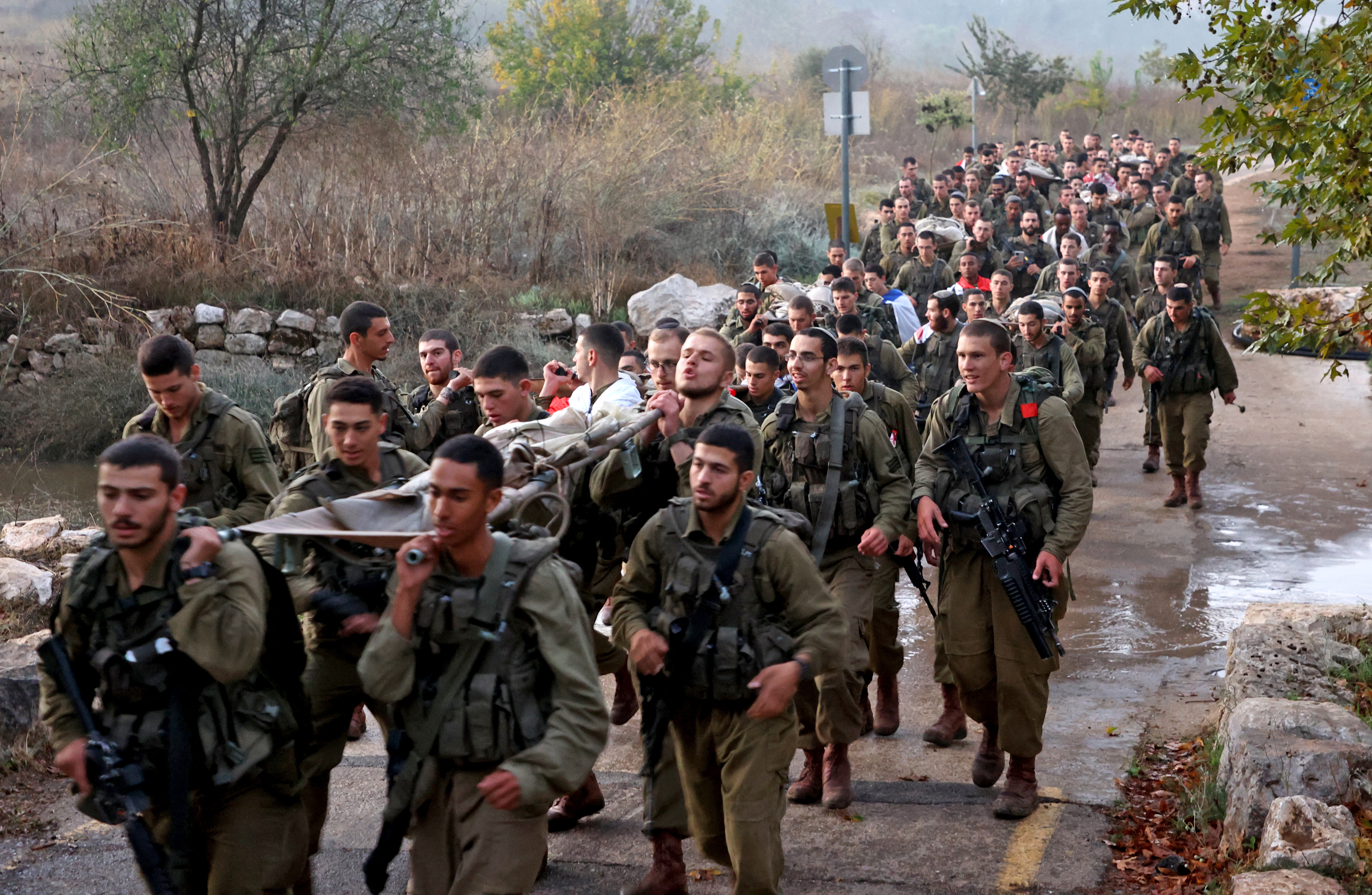 Newly-recruited Israeli paratroopers march in full combat gear on a 50-kilometre 12-hour hike in the mountains near Jerusalem on November 10, 2022.
