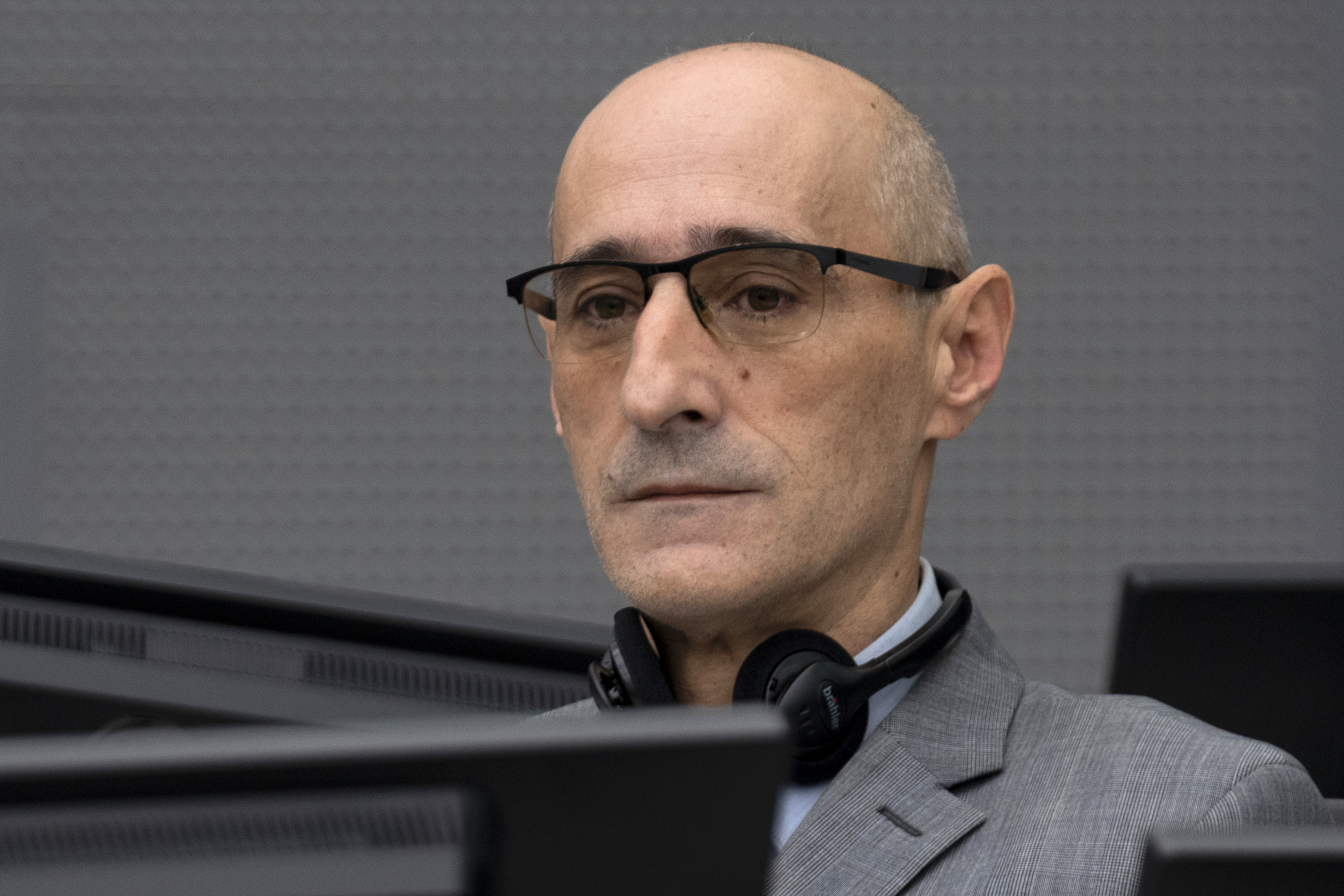 Salih Mustafa, a former Kosovo rebel, waits in the Kosovo Specialist Chambers court for the judges to read the verdict in The Hague, on December 16, 2022. - Mustafa is charged with the war crimes of arbitrary detention, cruel treatment, the torture of at least six people and the murder of one person at a detention compound in Zllash, Kosovo, in April 1999. Salih Mustafa pleaded not guilty to all charges. (Photo by Peter Dejong / ANP / AFP) / Netherlands OUT