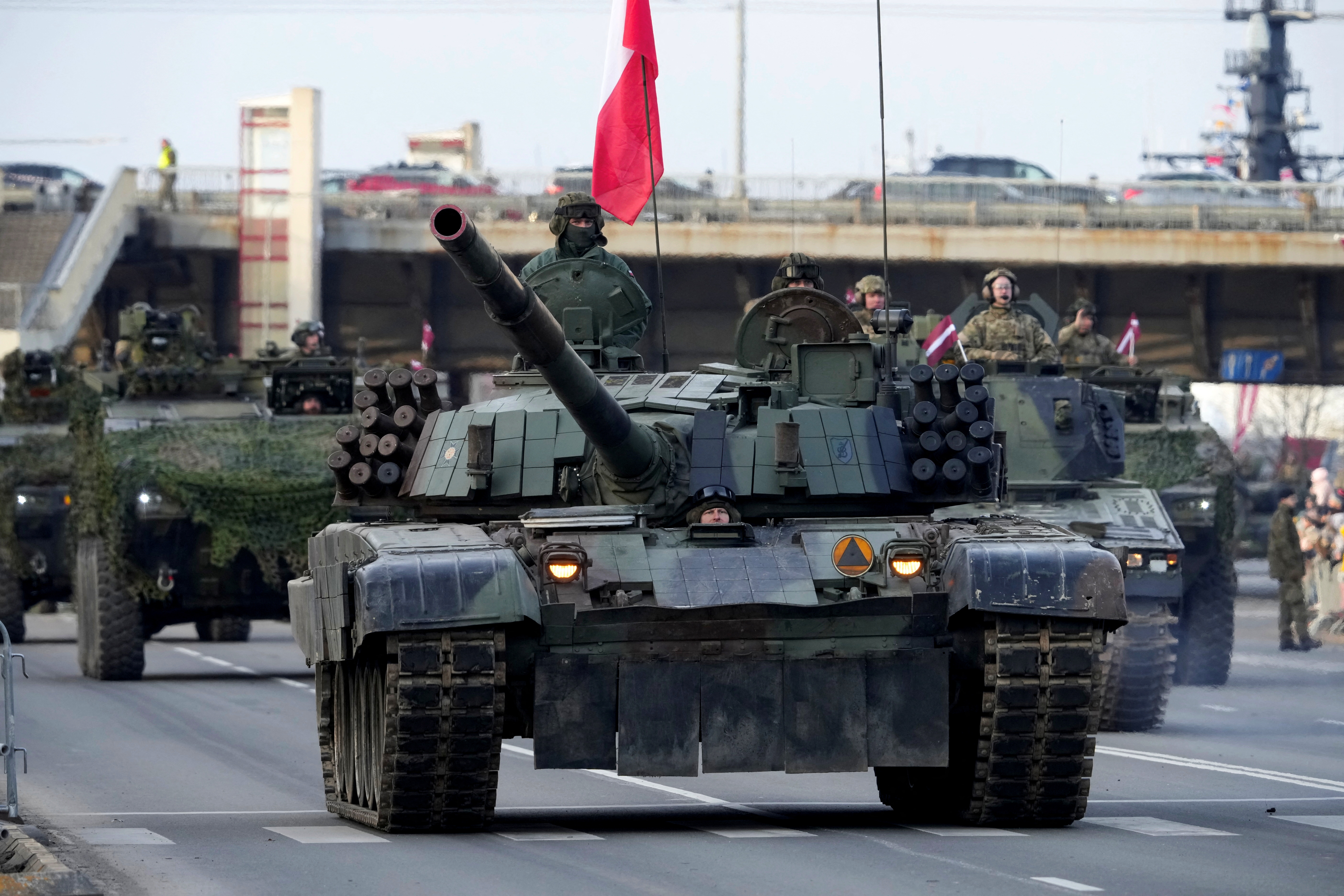 Polish army servicemen of NATO enhanced Forward Presence battlegroup with their PT-91 Twardy tank attend a military parade to celebrate Latvia's anniversary of independence declaration in Riga, Latvia November 18, 2022. REUTERS/Ints Kalnins