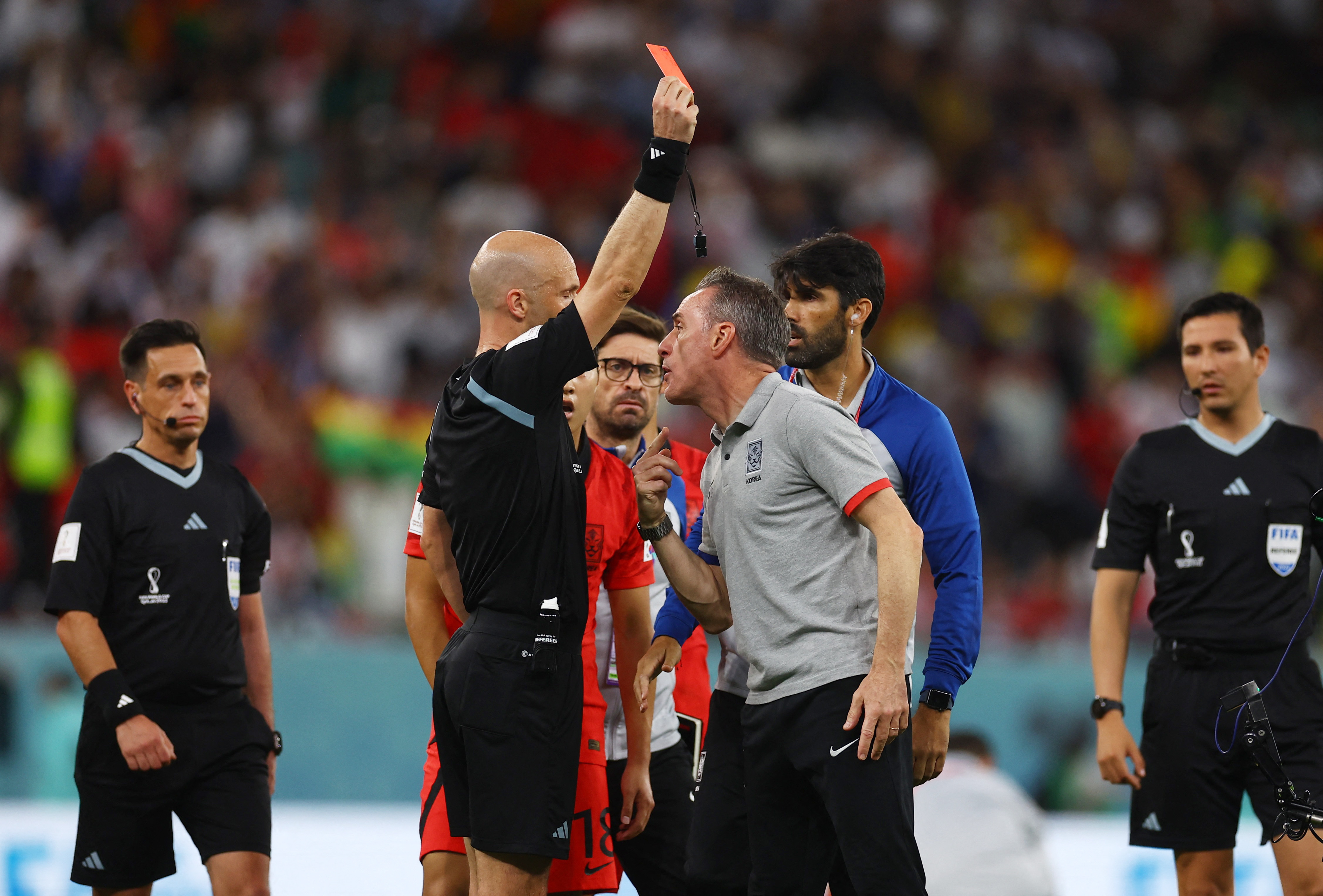 Soccer Football - FIFA World Cup Qatar 2022 - Group H - South Korea v Ghana - Education City Stadium, Al Rayyan, Qatar - November 28, 2022 South Korea coach Paulo Bento is shown a red card by referee Anthony Taylor REUTERS/Kai Pfaffenbach