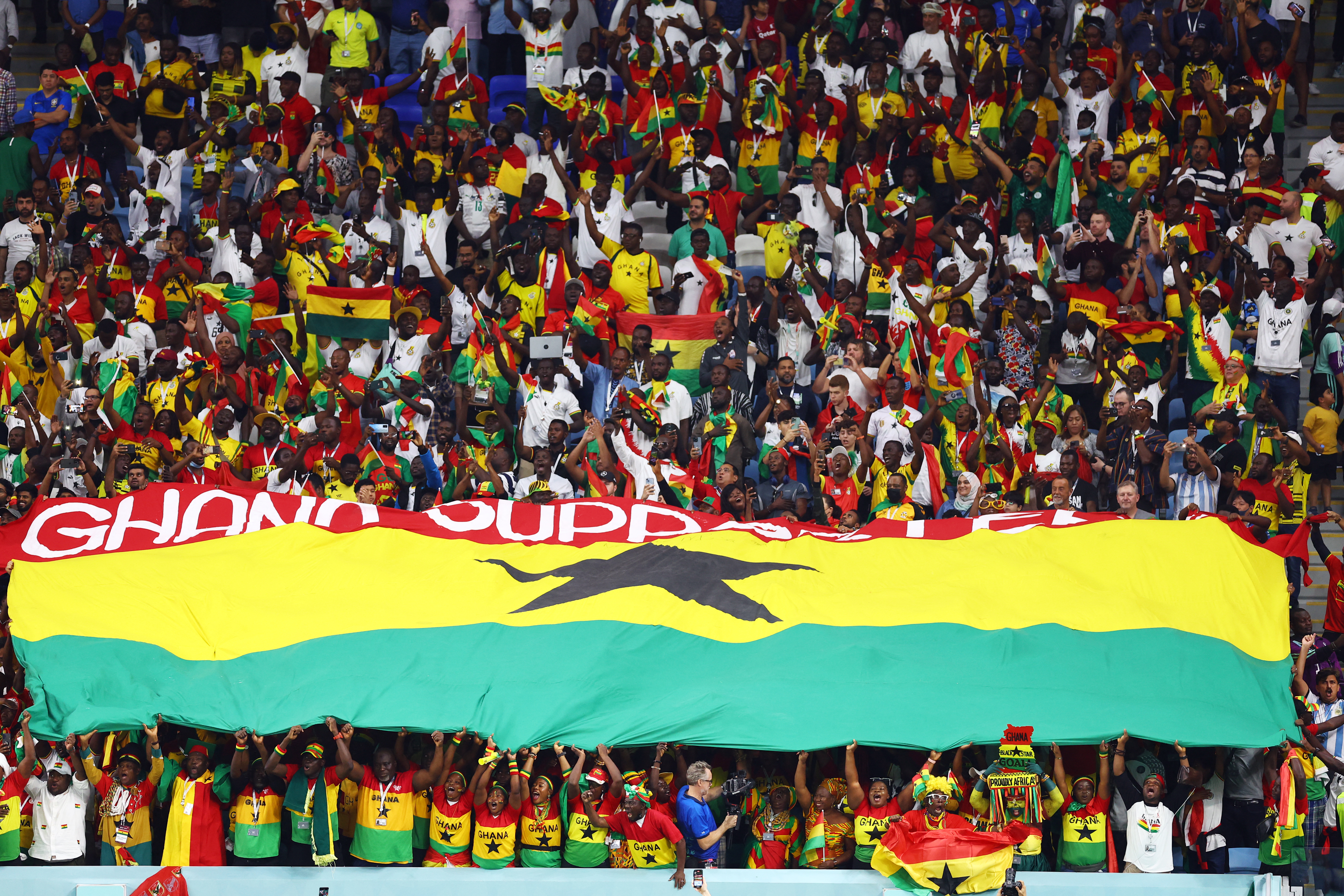 Fans hold a Ghana flag inside the stadium