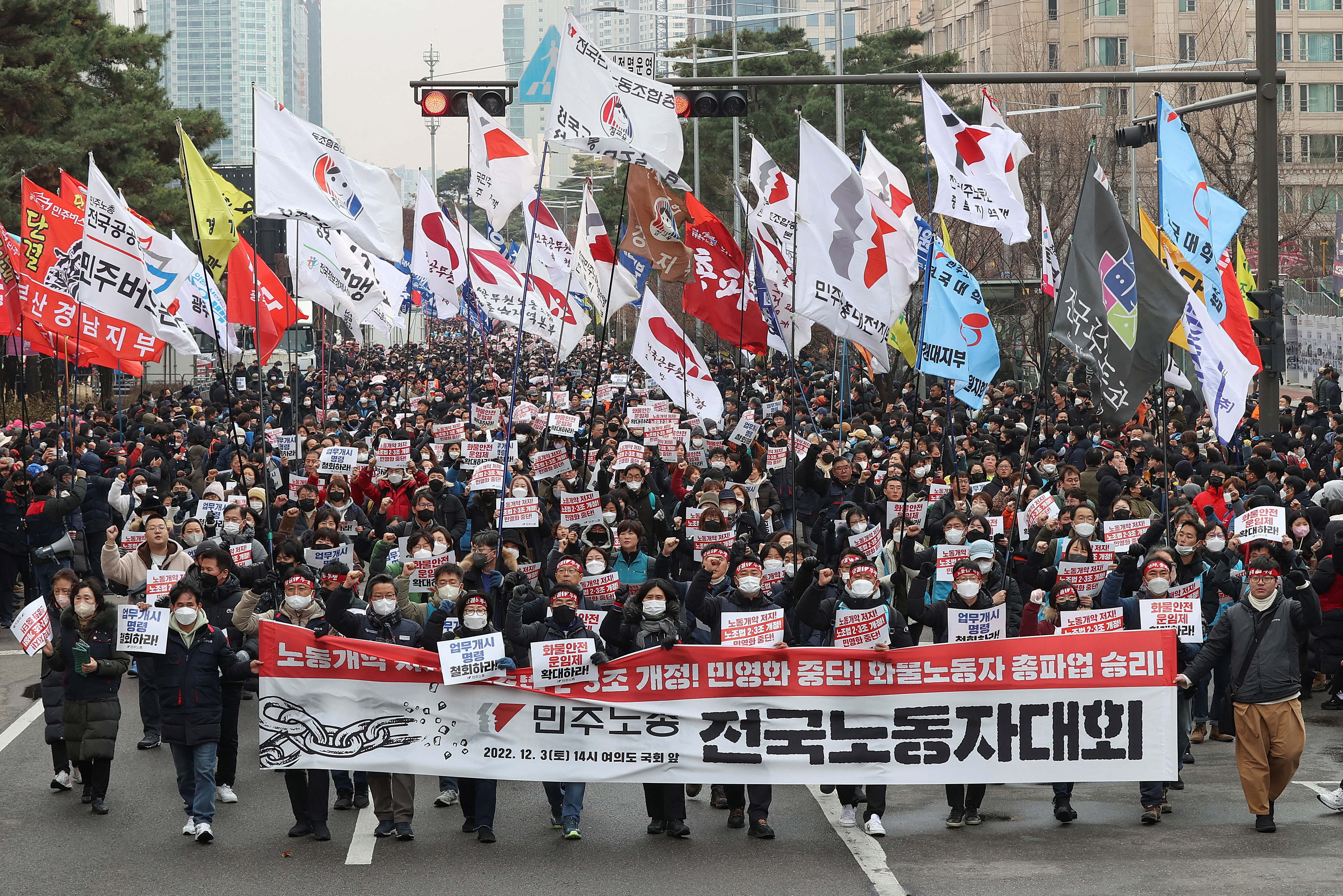 South Korean workers march during a rally in support of the ongoing strike by truckers near the National Assembly in Seoul, South Korea.