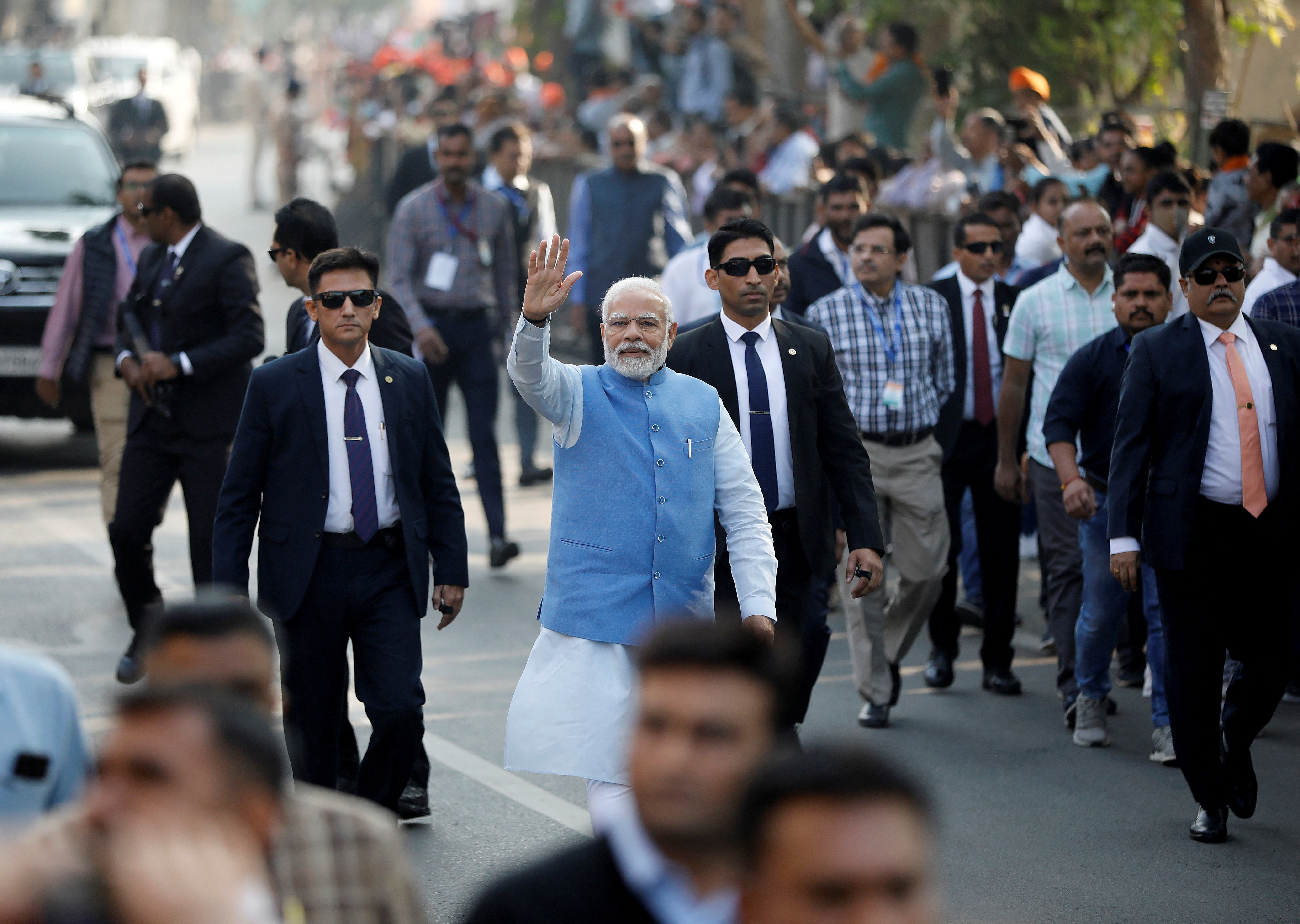 India's Prime Minister Narendra Modi waves to his supporters as he arrives to cast his vote during the second and last phase of Gujarat state assembly elections in Ahmedabad, India, December 5, 2022. REUTERS/Amit Dave