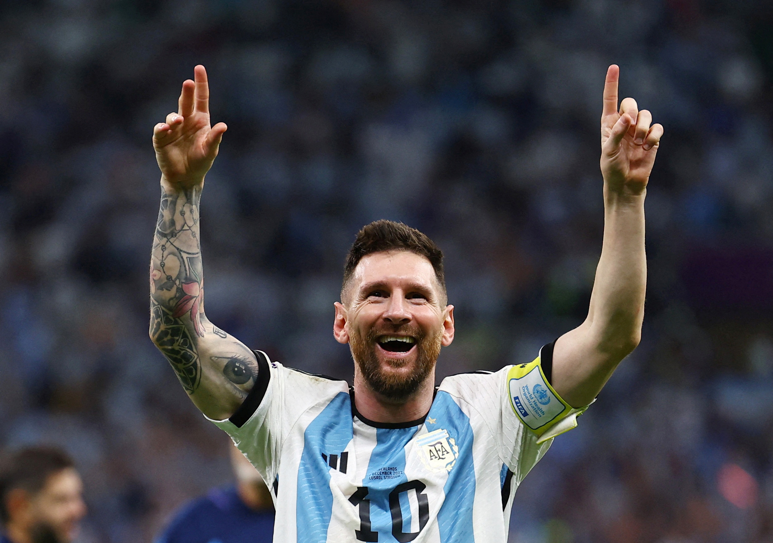 Argentina's Lionel Messi celebrates with arms held high in victory as Argentina progress to the semifinals of the World Cup 2022.
