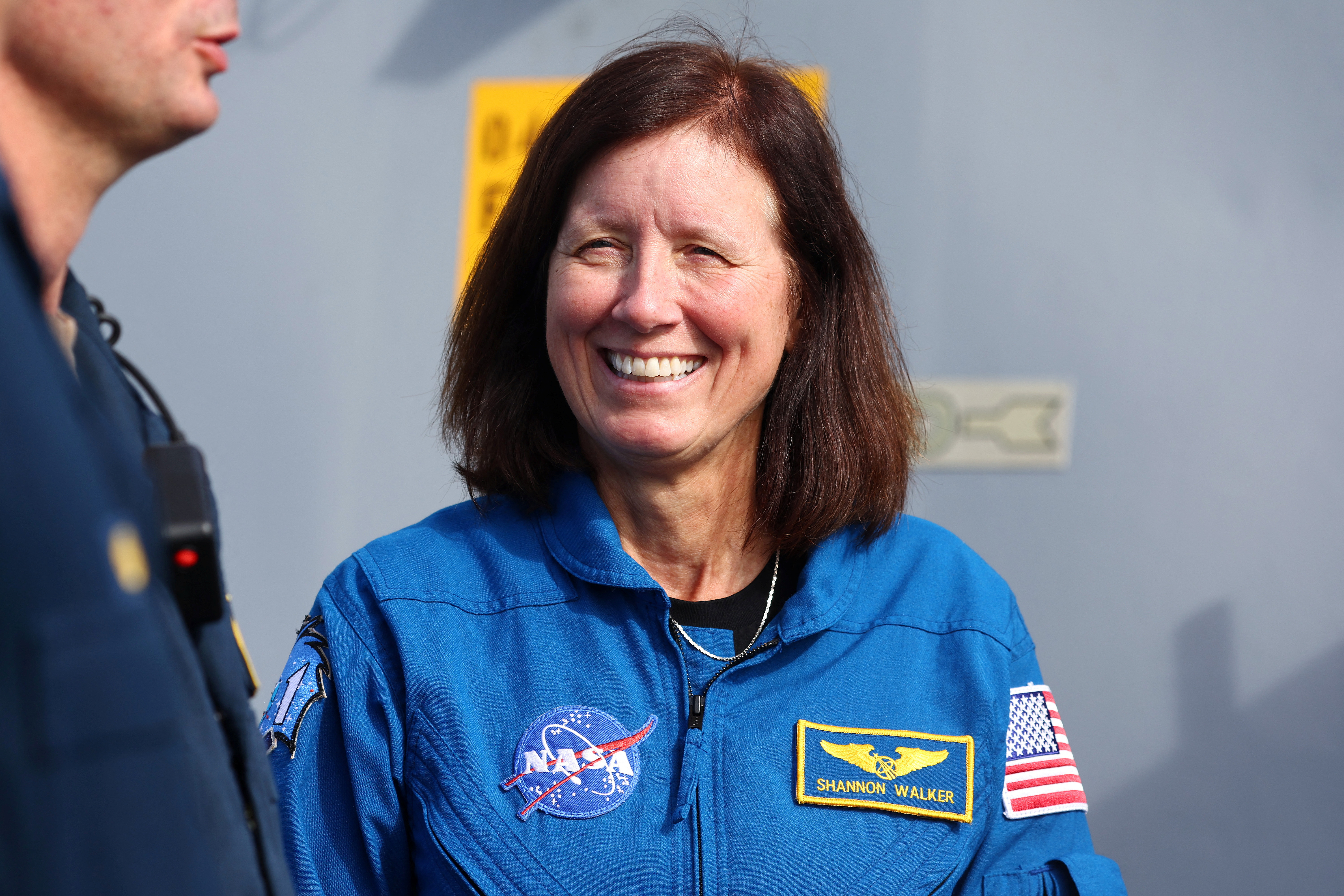 NASA astronaut Shannon Walker speaks with crew members during recovery operations