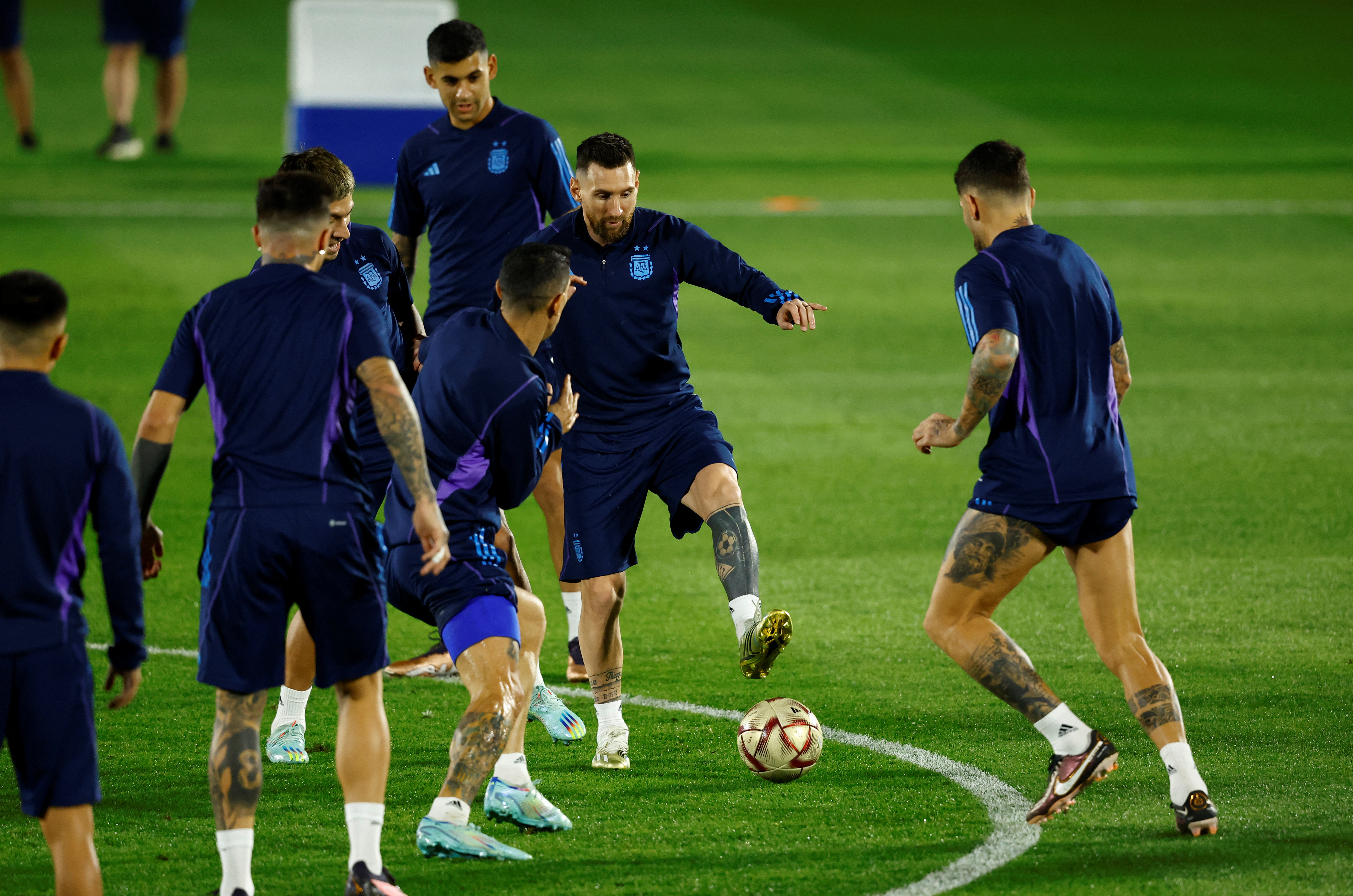 Argentina's Lionel Messi with Cristian Romero and teammates during training