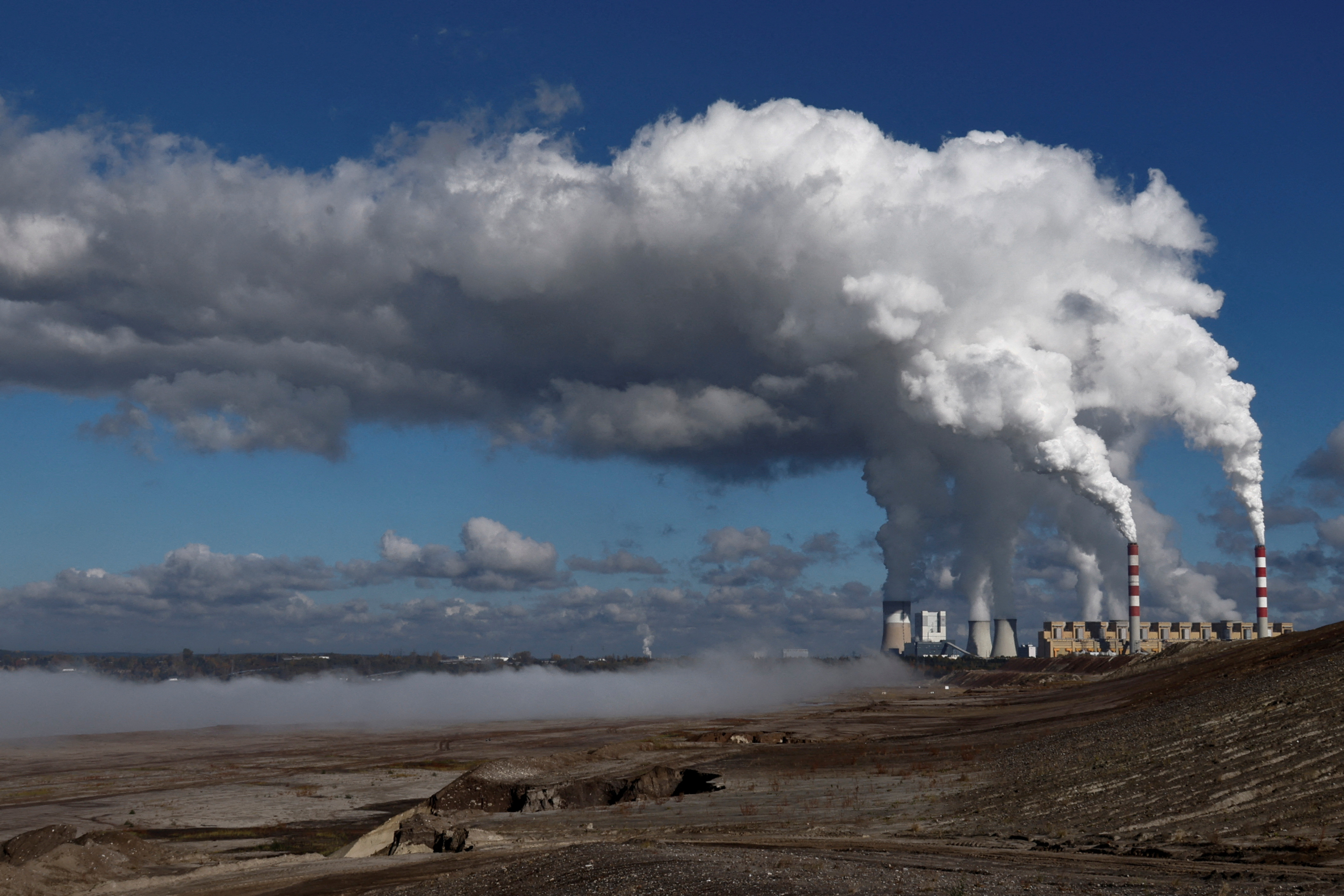 FILE PHOTO: Smoke and steam billow from Belchatow Power Station, Europe's largest coal-fired power plant powered by lignite, in Kleszczow, Poland October 20, 2022. REUTERS/Kuba Stezycki/File Photo