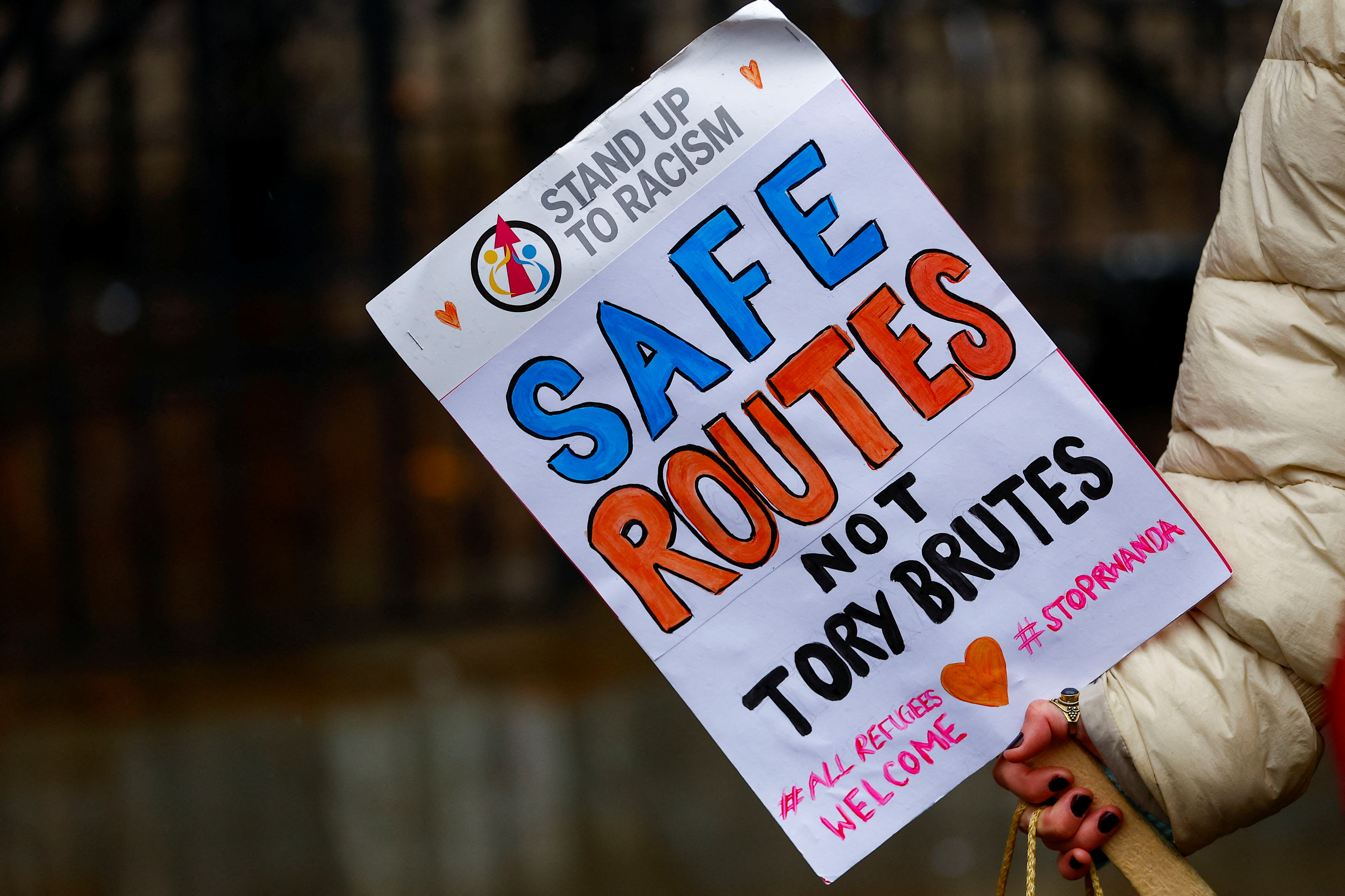 A protestor holds a placard while demonstrating outside the High Court