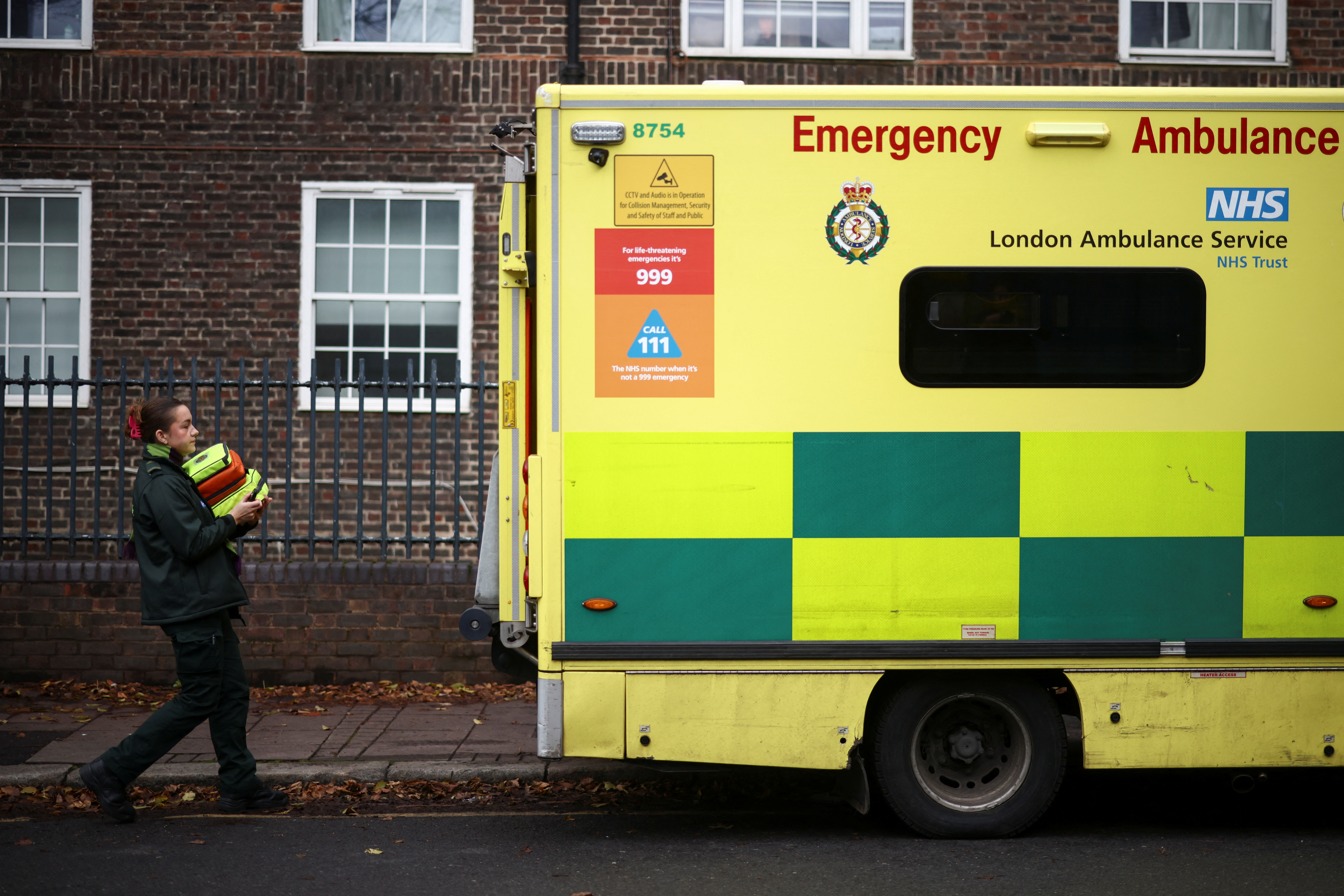 An NHS staff member carries items