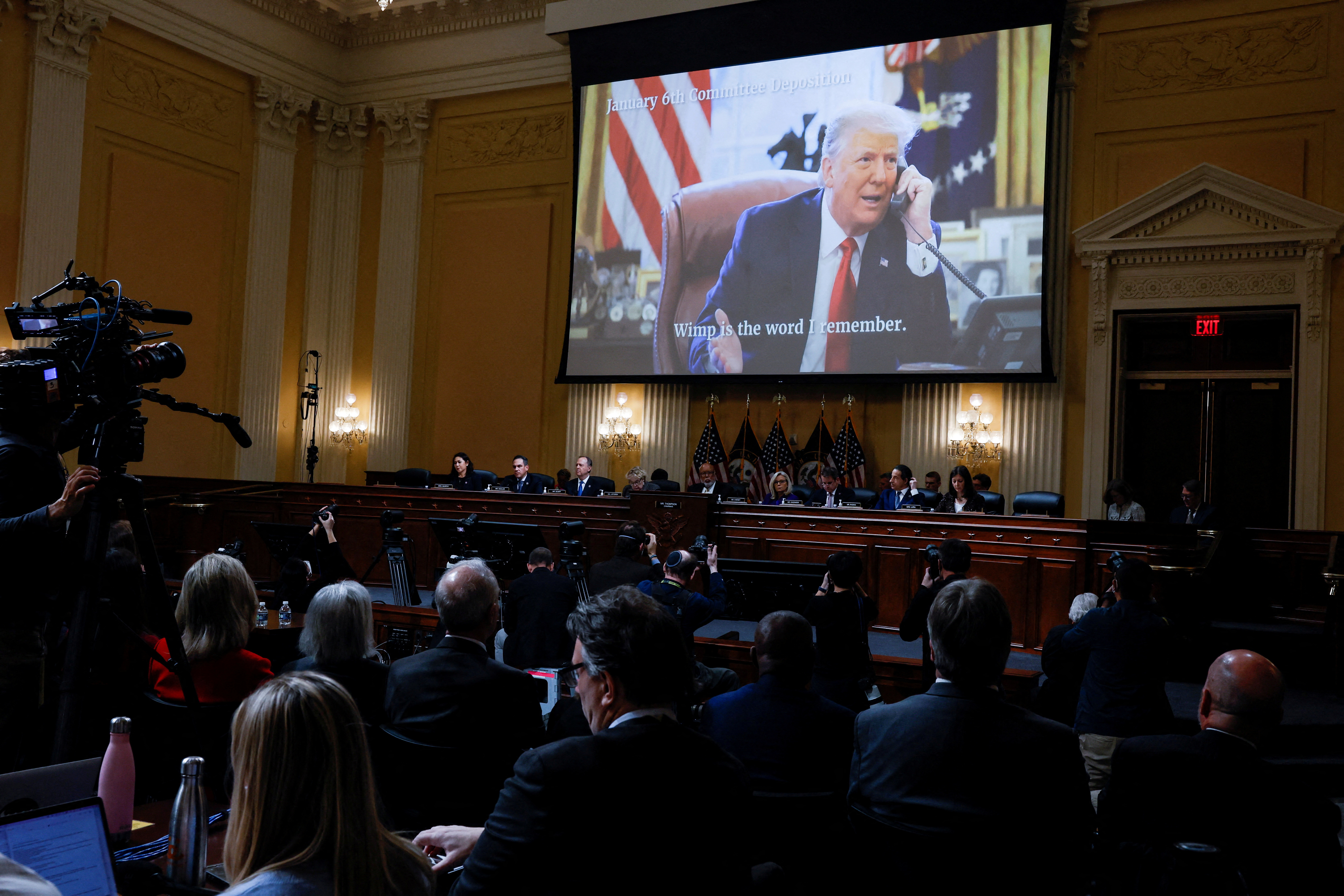 FILE PHOTO: Members of the U.S. House Select Committee investigating the January 6 Attack on the U.S. Capitol sit beneath an image showing former President Donald Trump speaking on the telephone in the Oval Office during the final meeting of the U.S. House Select Committee investigating the January 6 Attack on the U.S. Capitol, on Capitol Hill in Washington, U.S., December 19, 2022. REUTERS/Evelyn Hockstein/File Photo