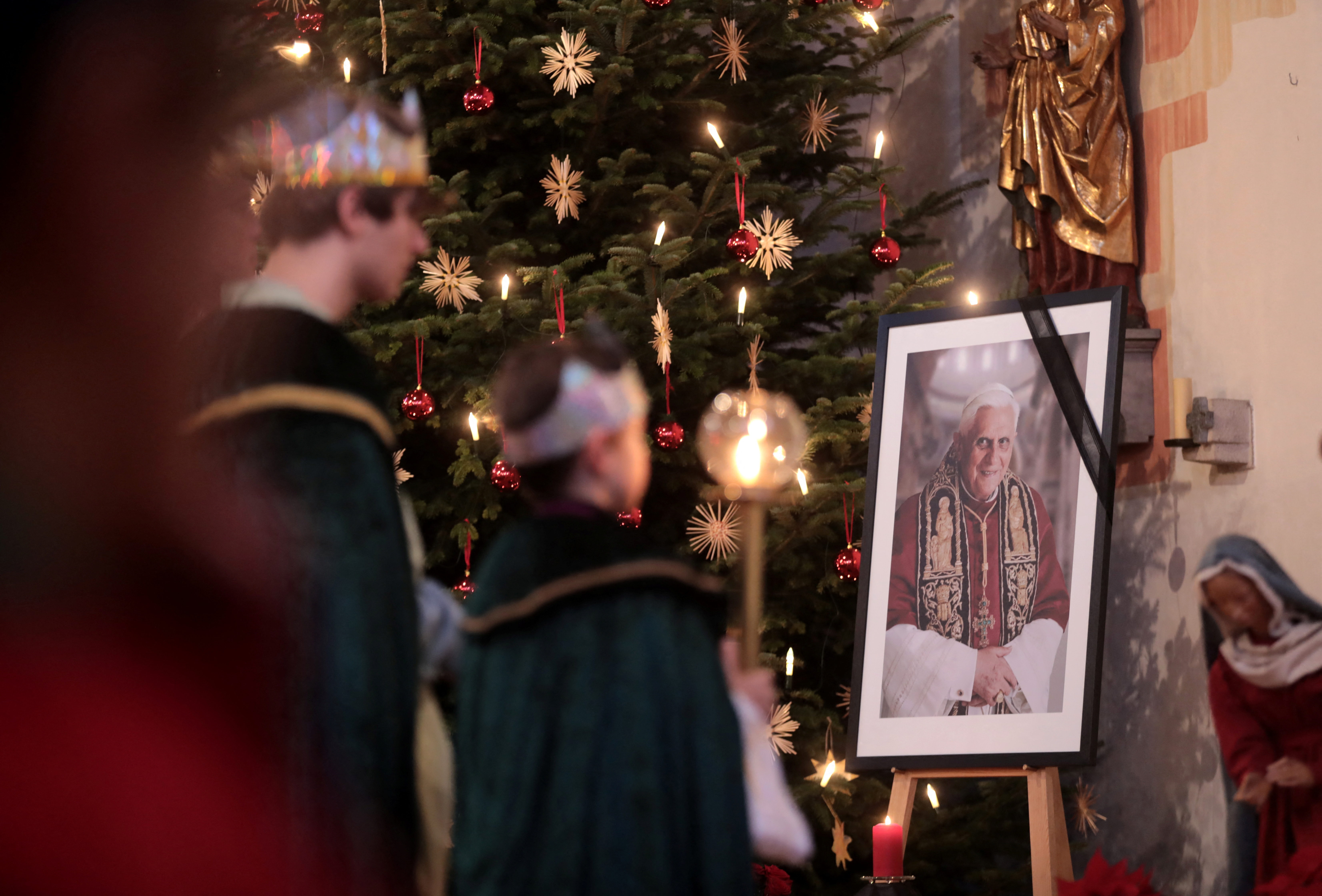 People take part in a service at St Oswald Church, baptistery of former Pope Benedict after his death, in Marktl, Germany.