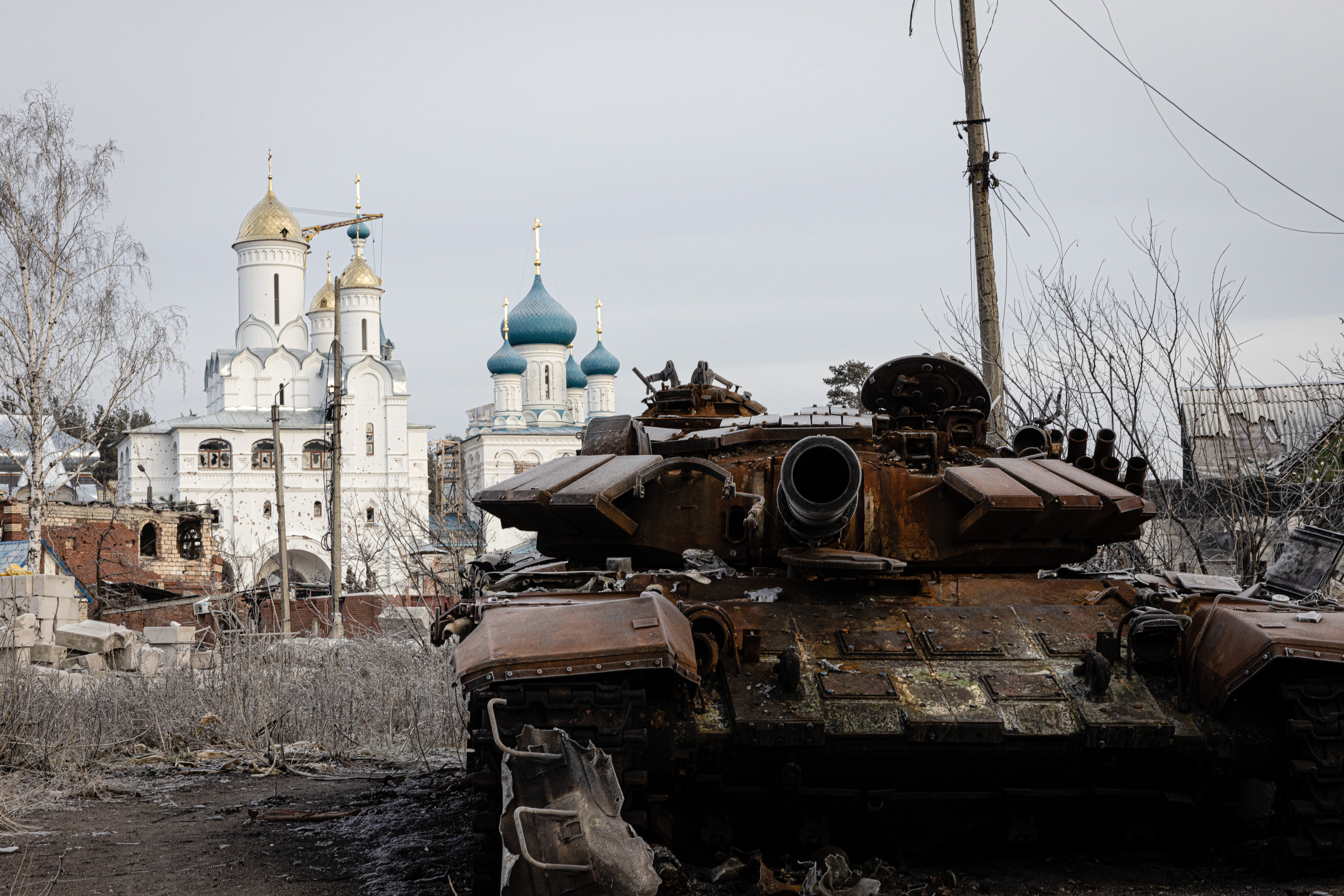 Ruined tank in front of a church
