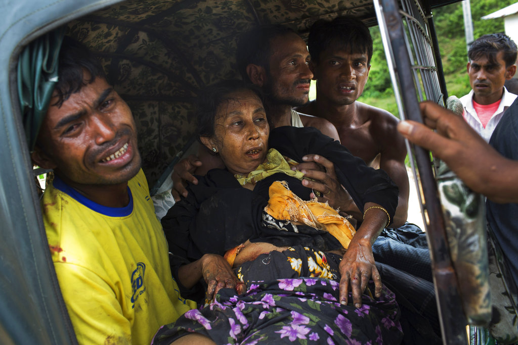 An injured elderly woman and her relatives rush to a hospital on an autorickshaw, near the border town of Kutupalong, Bangladesh, after the Rohingya woman encountered a landmine that blew off her right leg while trying to cross into Bangladesh.