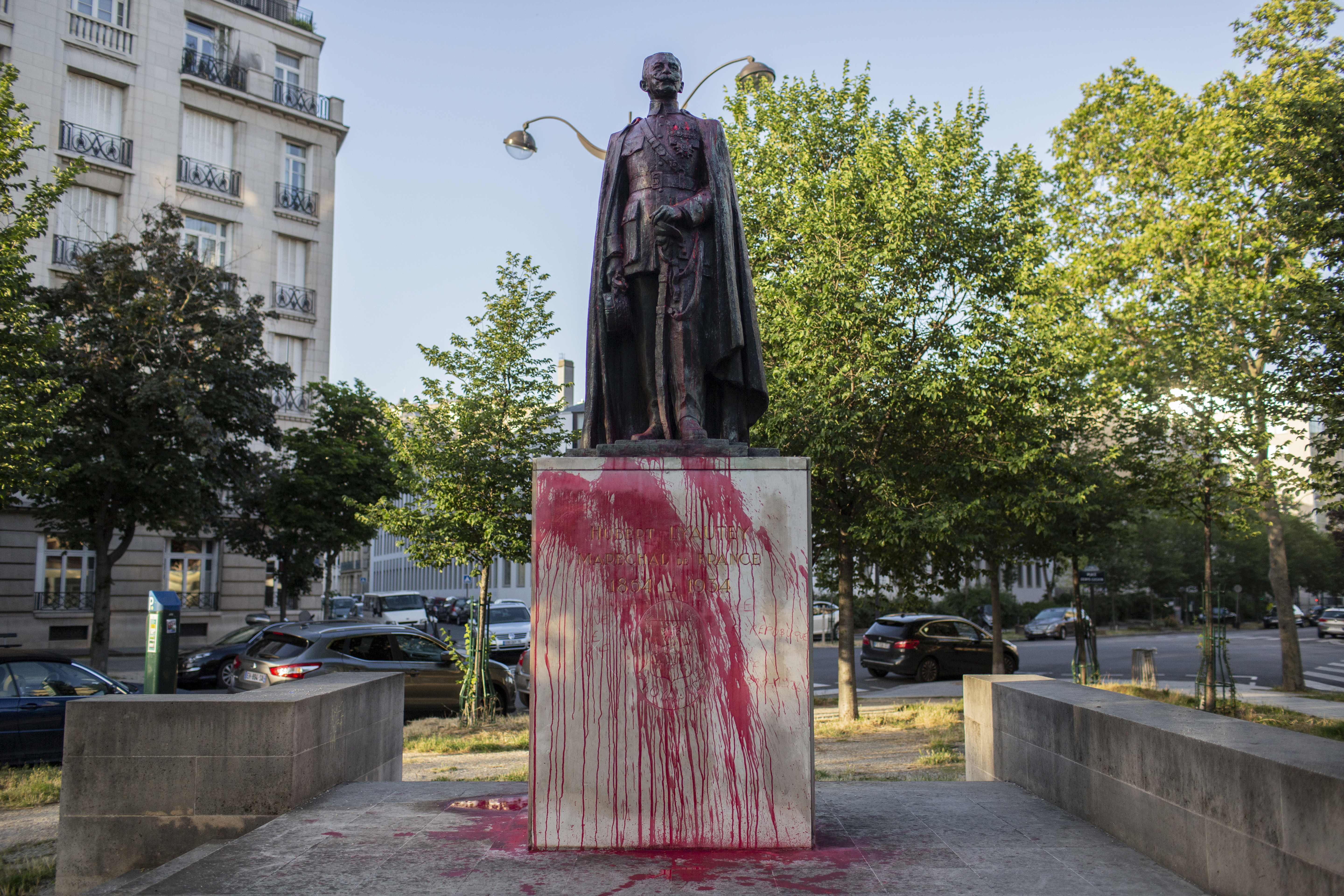 The statue of Hubert Lyautey, who served in Morocco, Algeria, Madagascar and Indochina when they were under French control, is offered with red painting Monday, June 22, 2020. Two statues related to France's colonial era were covered in graffiti Monday amid a global movement to take down monuments to figures tied to slavery or colonialism. (AP Photo/Rafael Yaghobzadeh)