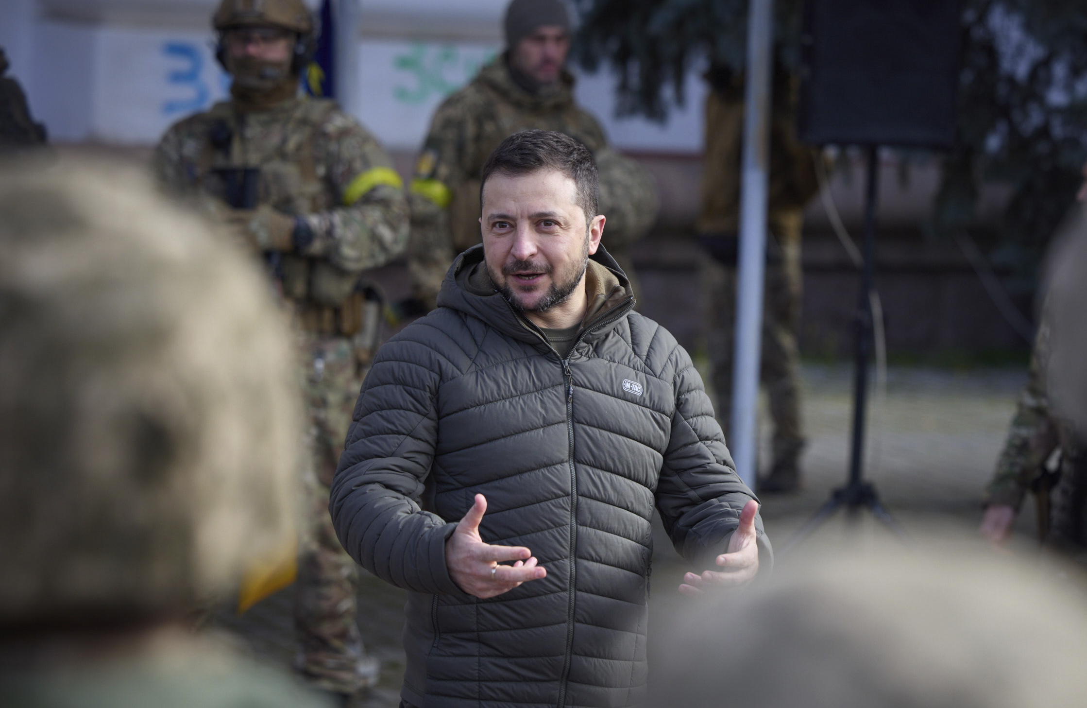 Ukrainian President Volodymyr Zelenskyy talks to soldiers