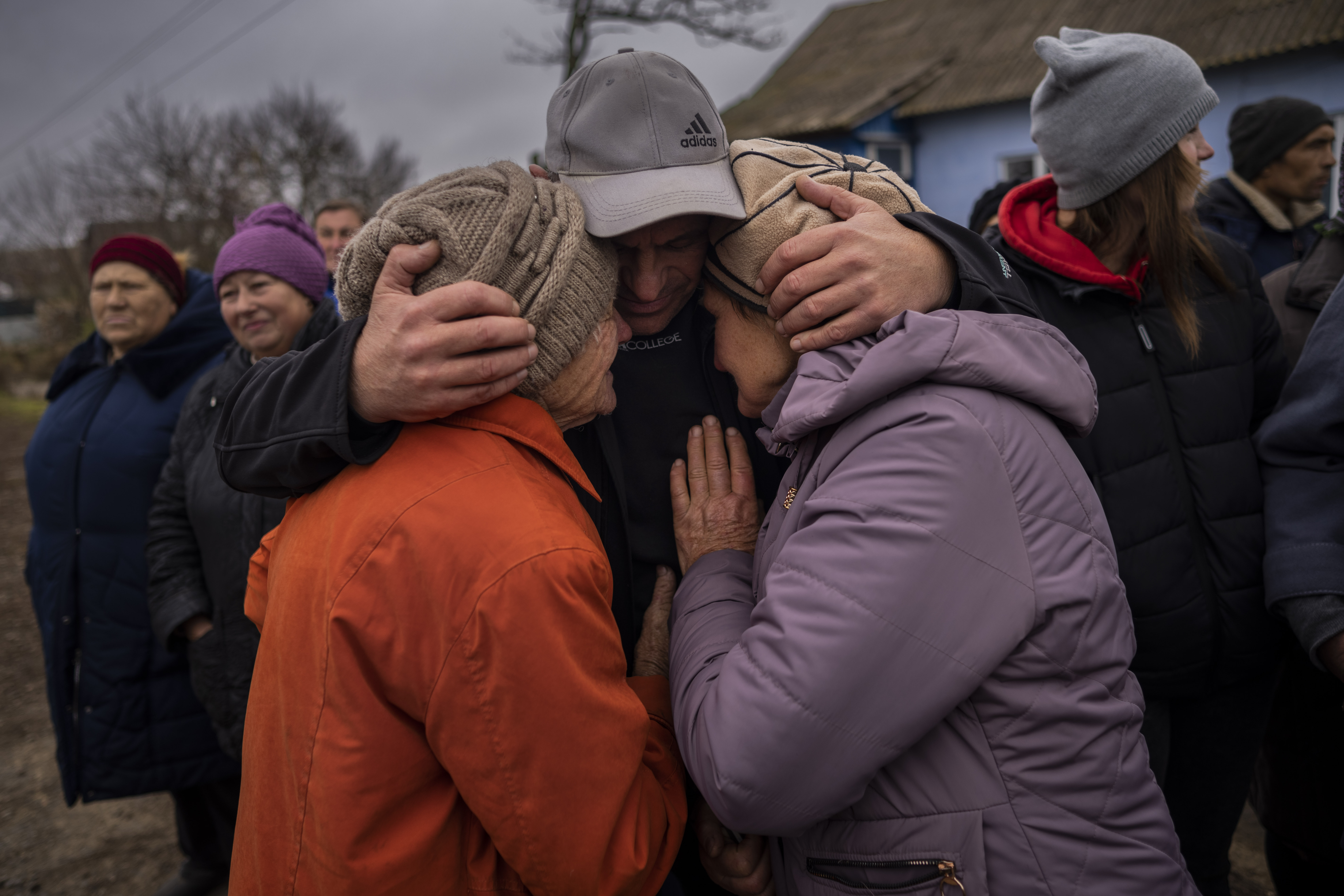 In the village of Tsentralne, Ukrainian family members meet for the first time since Russian troops withdrew from the Kherson region, southern Ukraine, Sunday, Nov. 13, 2022. Families were torn apart when Russia invaded in February, as some fled and others hunkered down. (AP Photo/Bernat Armangue)