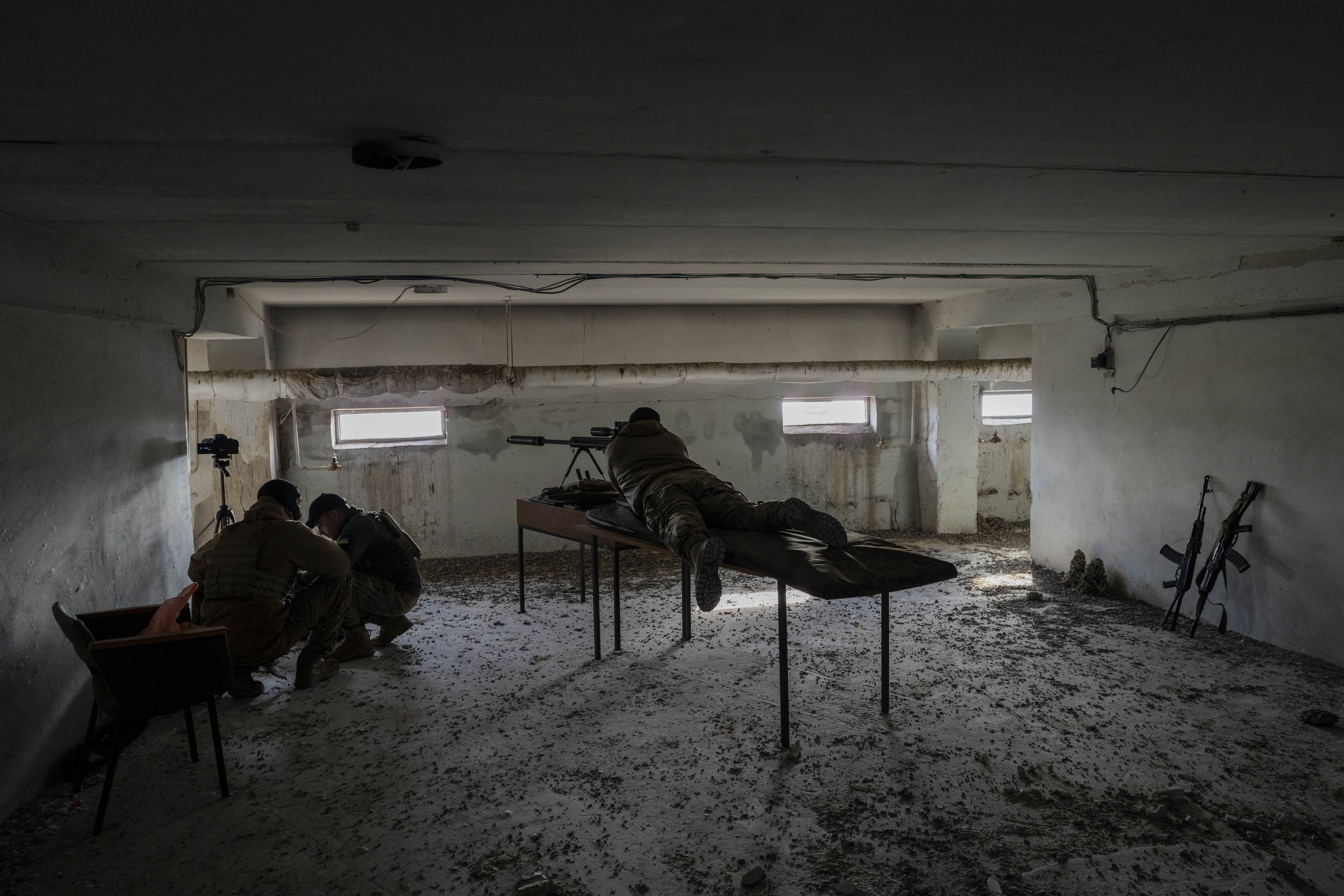 A sniper unit aims toward Russian positions during an operation, Kherson region, southern Ukraine, Saturday, Nov. 19, 2022. (AP Photo/Bernat Armangue)