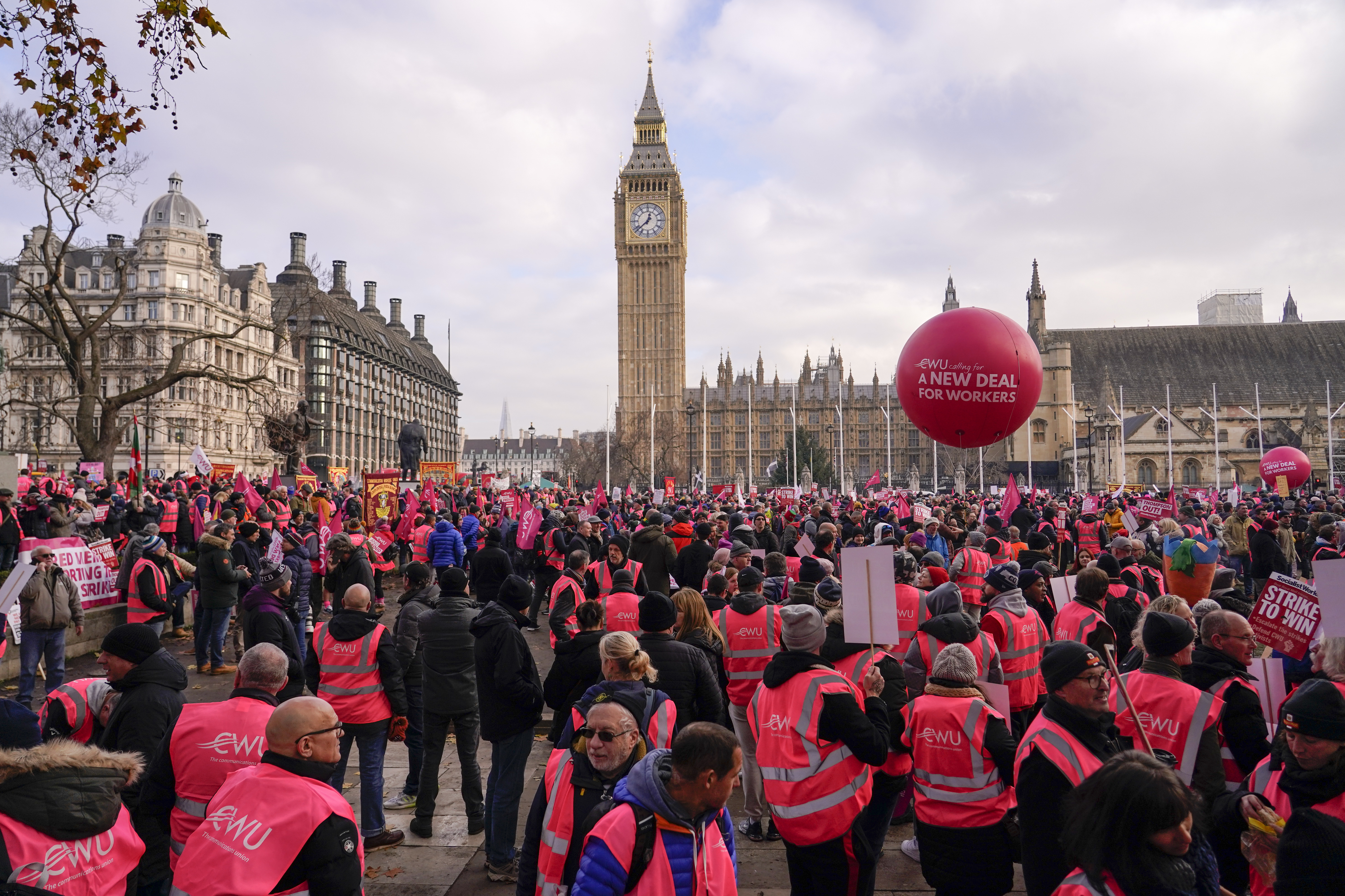 Royal Mail workers gather in Parliament Square, as they hold a protest over pay and jobs, in London, Friday, Dec. 9, 2022. The Communications Workers Union (CWU) has planned six days of strike over pay. (AP Photo/Alberto Pezzali)
