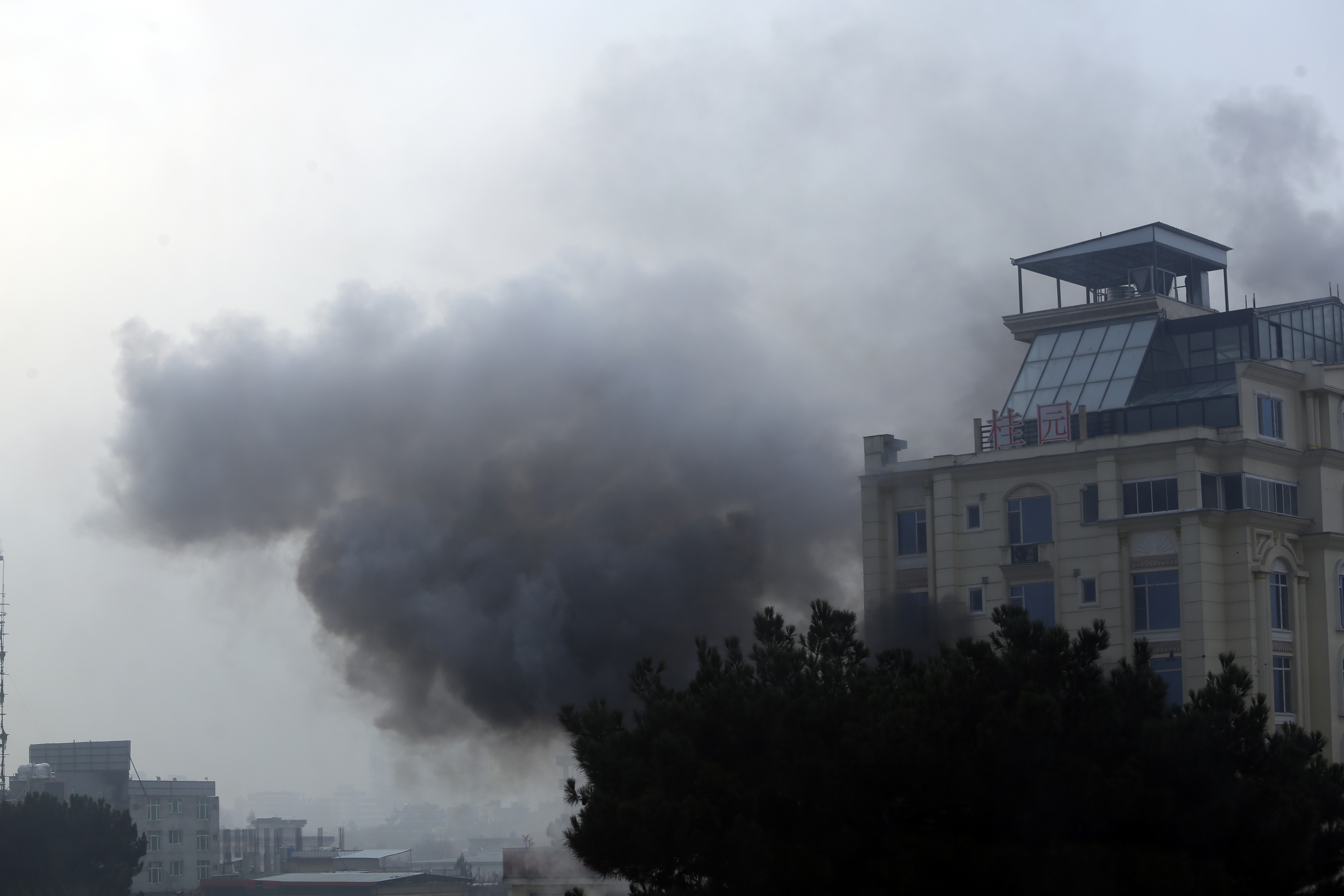 Smoke rises from a hotel building after an explosions and gunfire in the city of Kabul