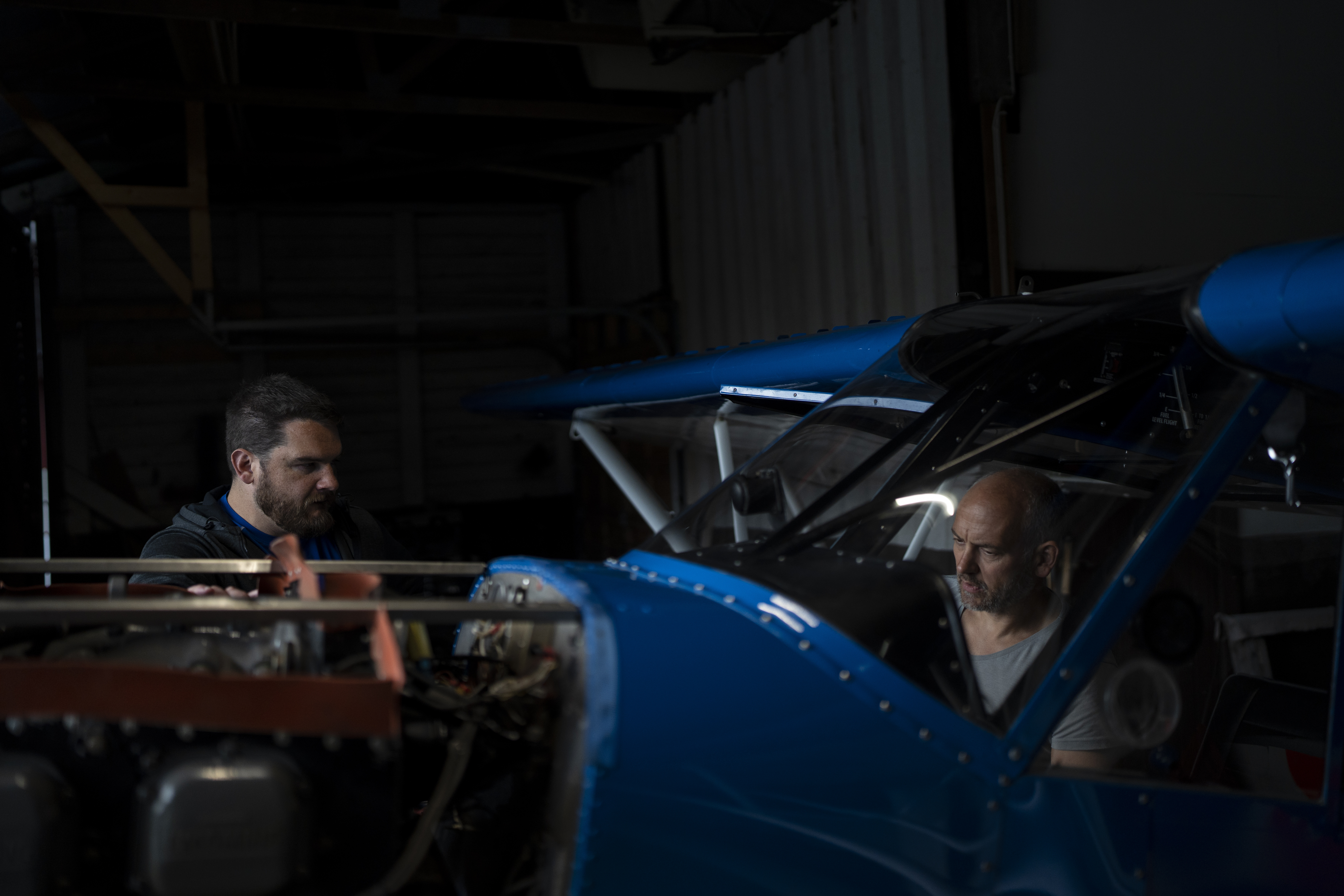 Garrett Fisher talks to a mechanic repairing his plane