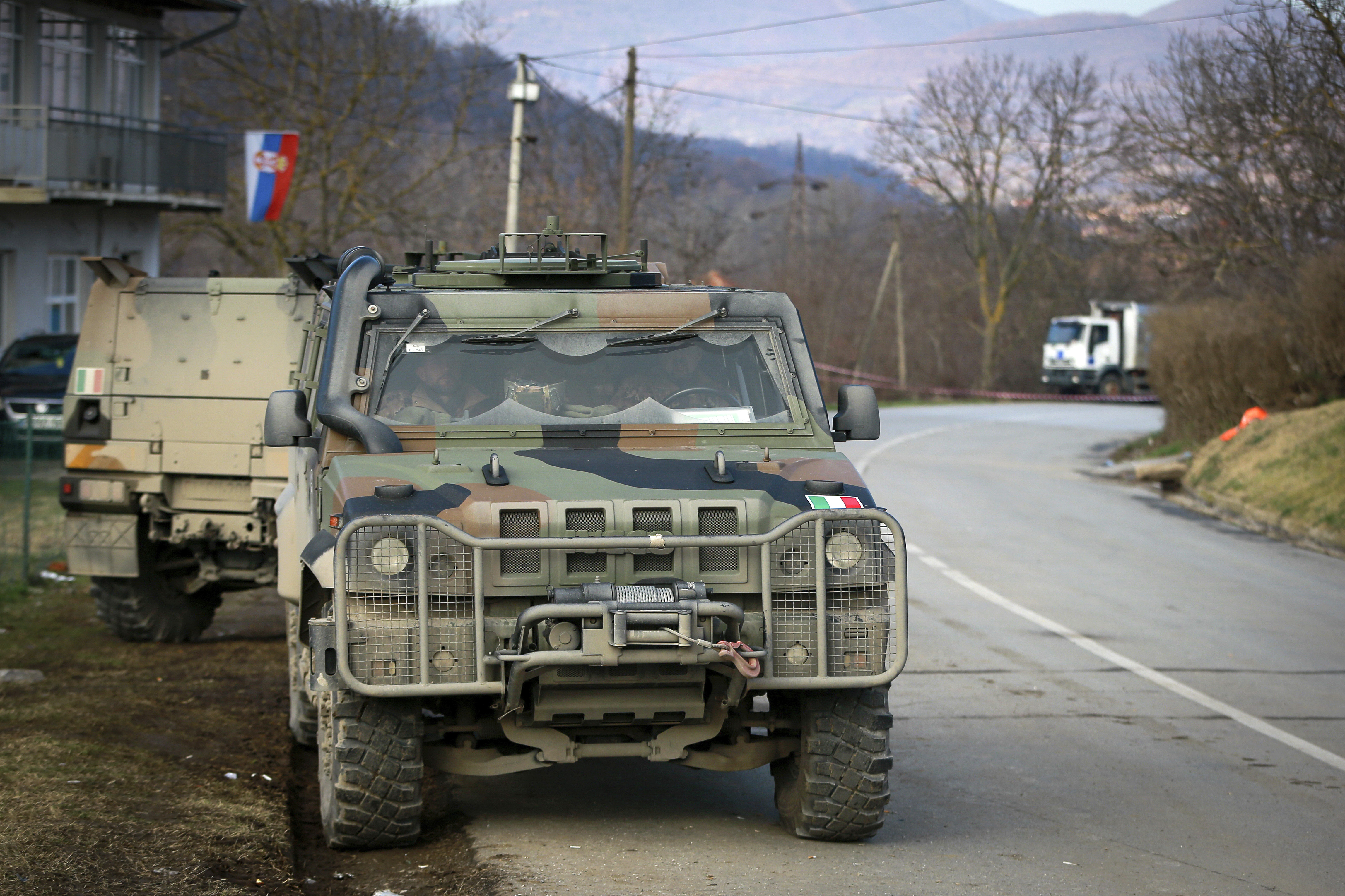Italian KFOR soldiers, part of the NATO peacekeeping force, park in front of the barricade near the village of Rudare, near the northern, Serb-dominated part of ethnically divided town of Mitrovica
