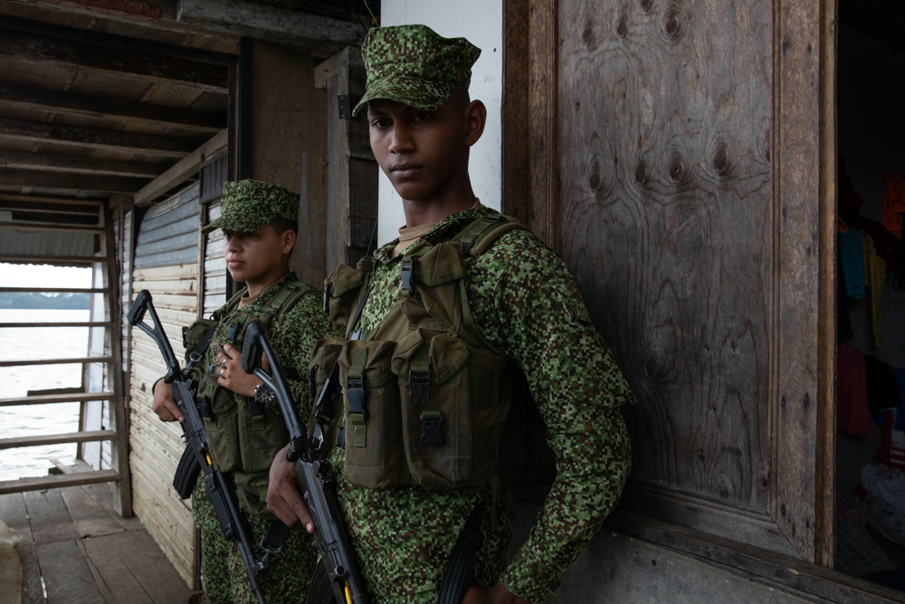 Armed men in military fatigues with guns