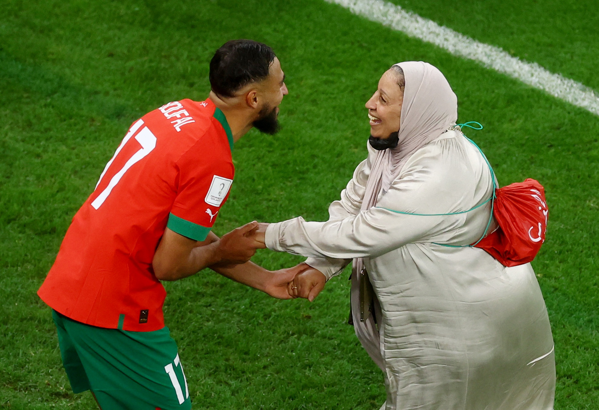 Moroccan player dancing with his mother on the football pitch