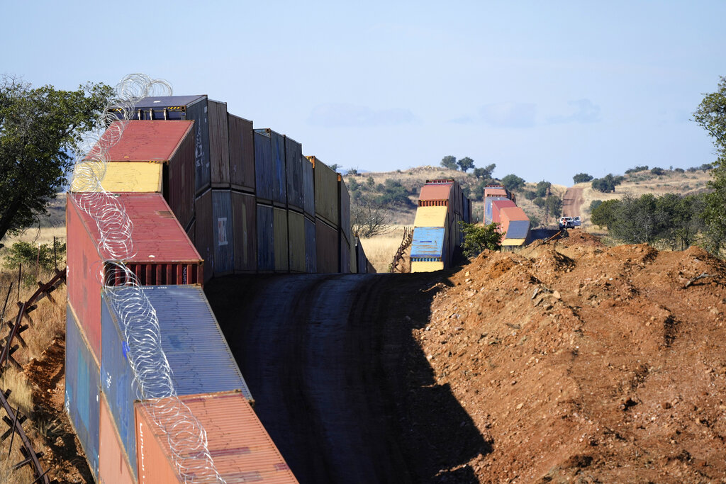 A makeshift border wall made of shipping containers on the US-Mexico border
