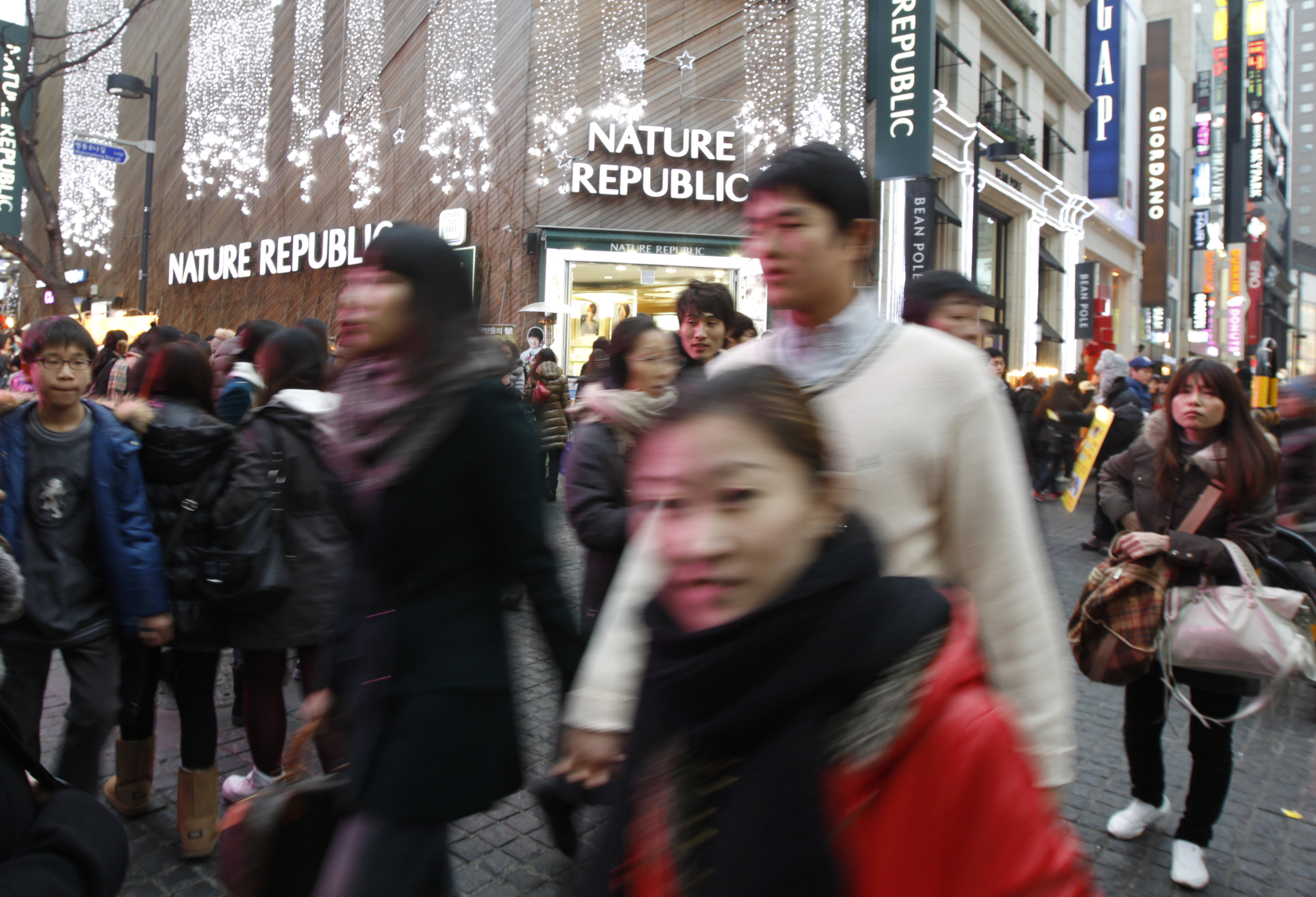 People walking in a crowded street in South Korea.