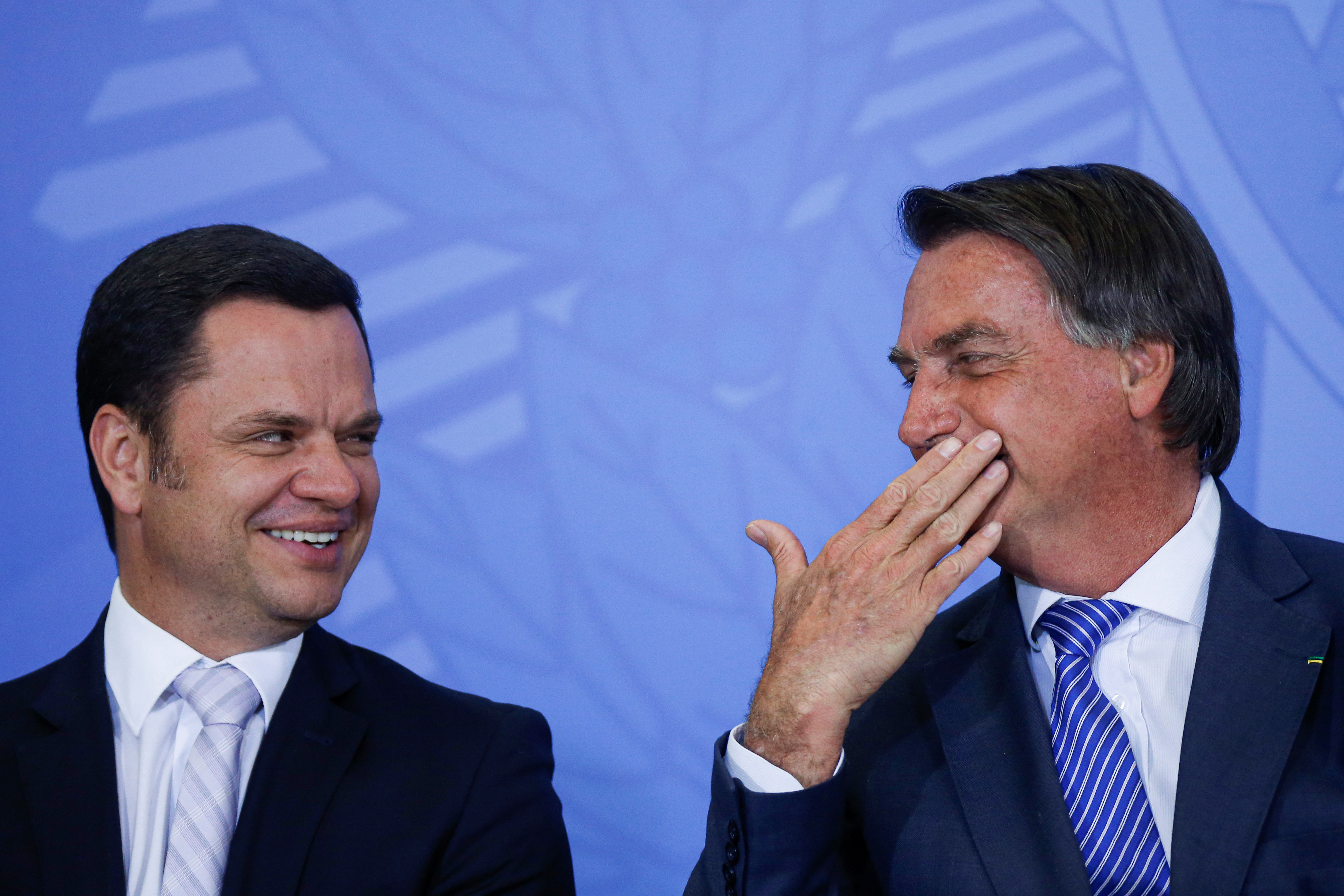 Brazil's Justice Minister Anderson Torres talks with Brazil's President Jair Bolsonaro during a ceremony at the Planalto Palace in Brasilia, Brazil September 13, 2021. REUTERS/Adriano Machado