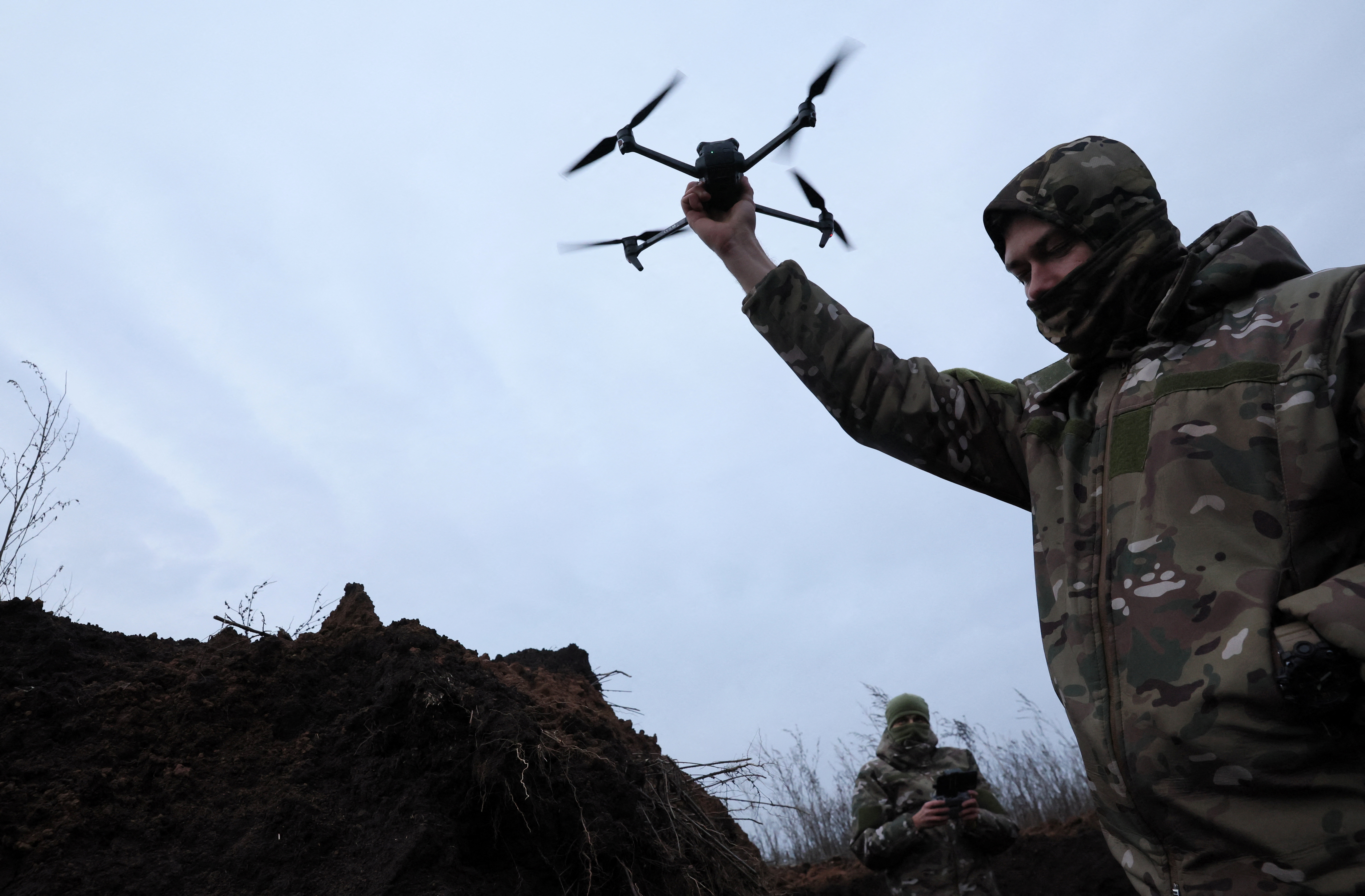 Two soldiers with the 58th Independent Motorized Infantry Brigade of the Ukrainian Army who wanted to be identified as "Ghost", 24, and "Soap", 30, test-fly a drone, as Russia's invasion of Ukraine continues, near Bakhmut, Ukraine, November 25, 2022.