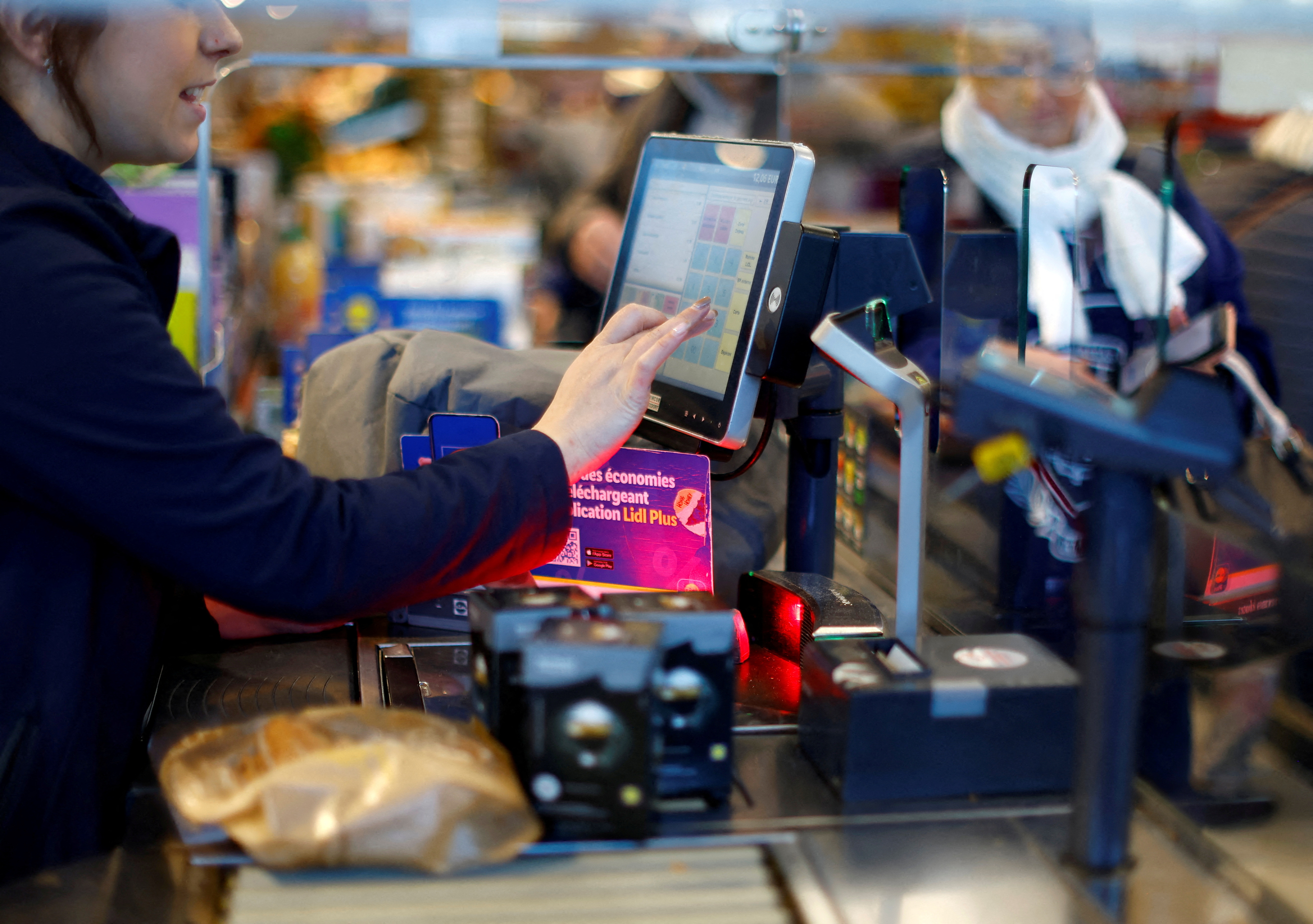 A cashier serves customers in a Lidl supermarket in Gattieres near Nice, France