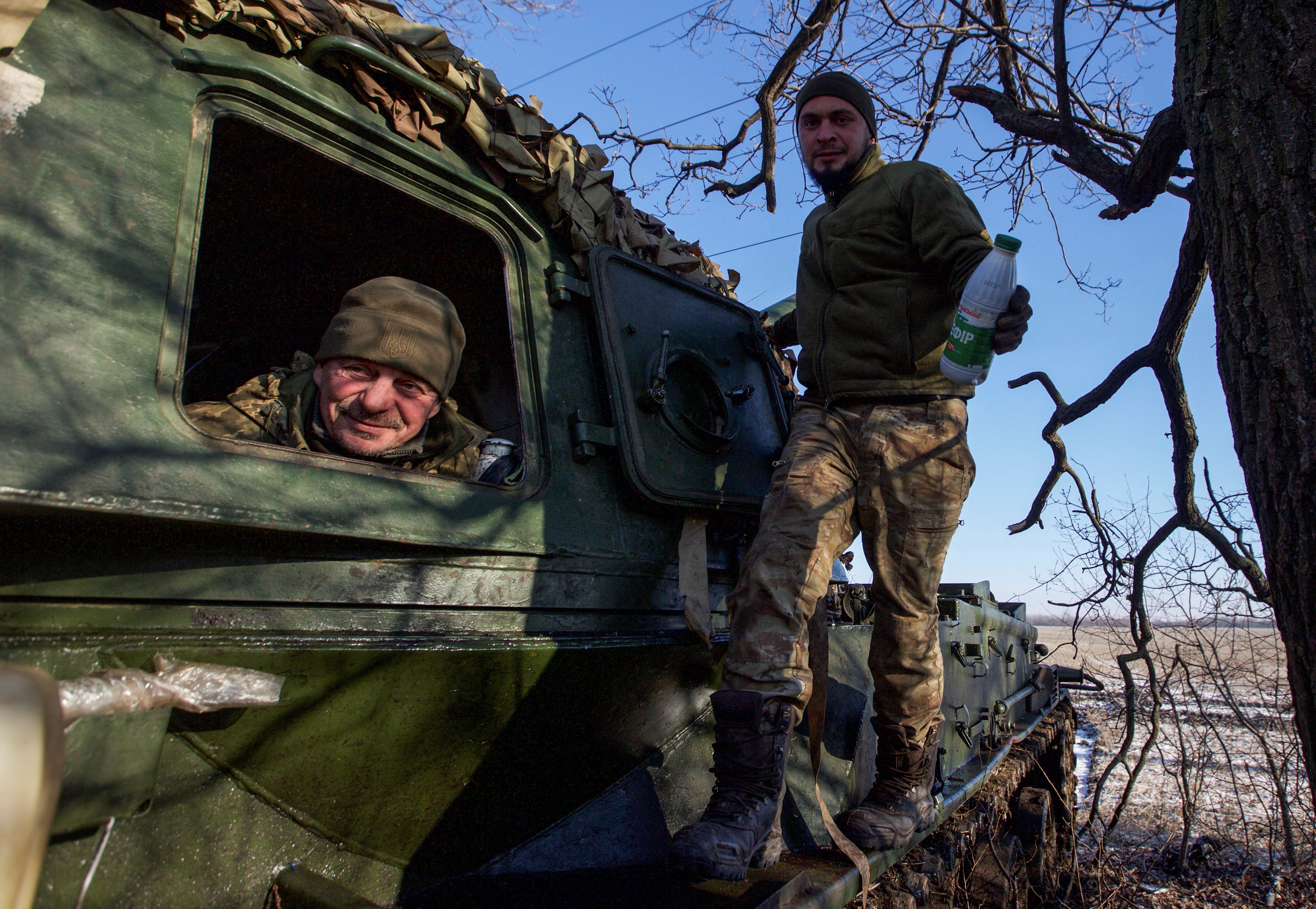 Ukrainian service members look on from a 2S3 Akatsiya self-propelled howitzer at their position in a front line in Donetsk region, Ukraine.