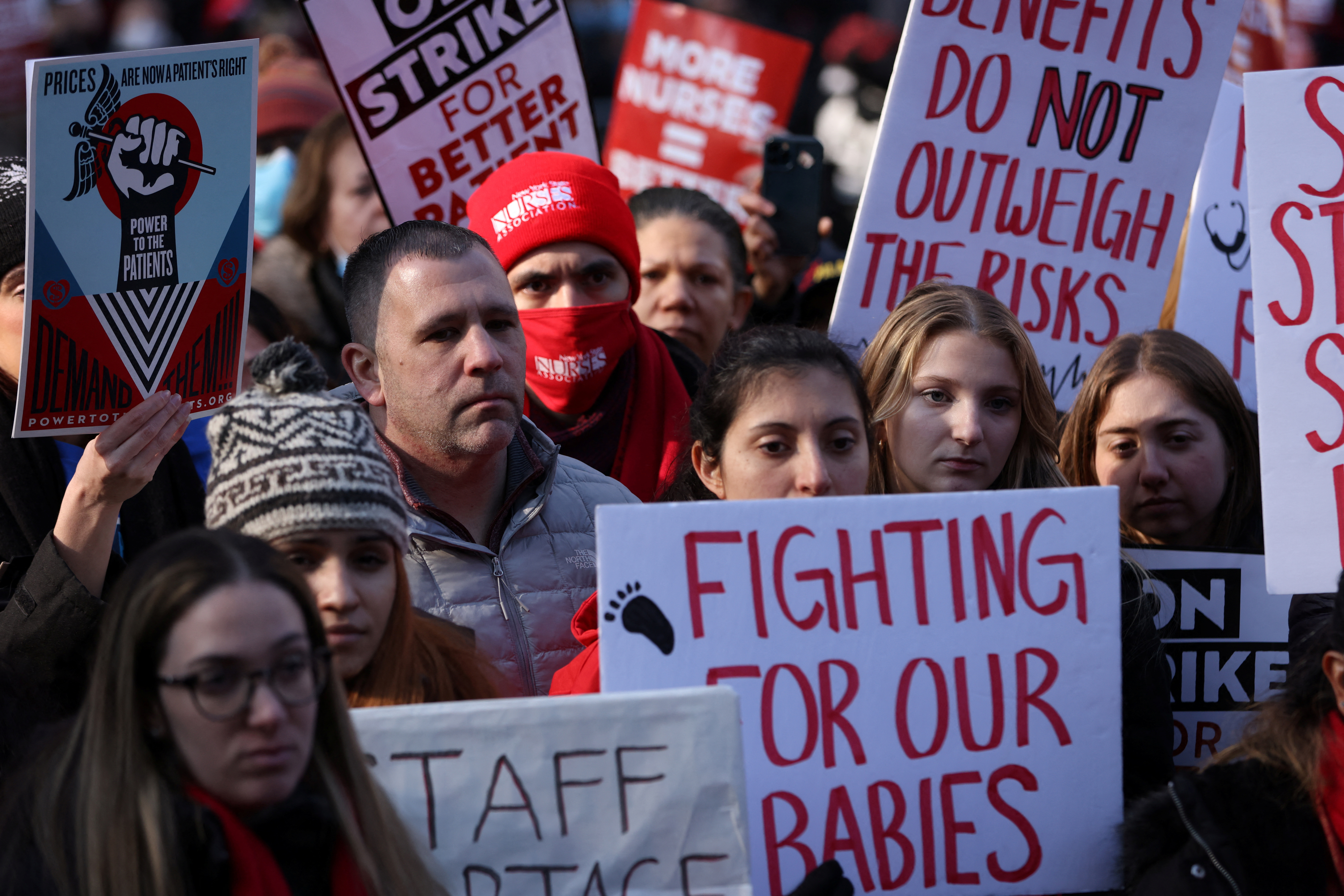 New York nurses hold banners as they walked off the job