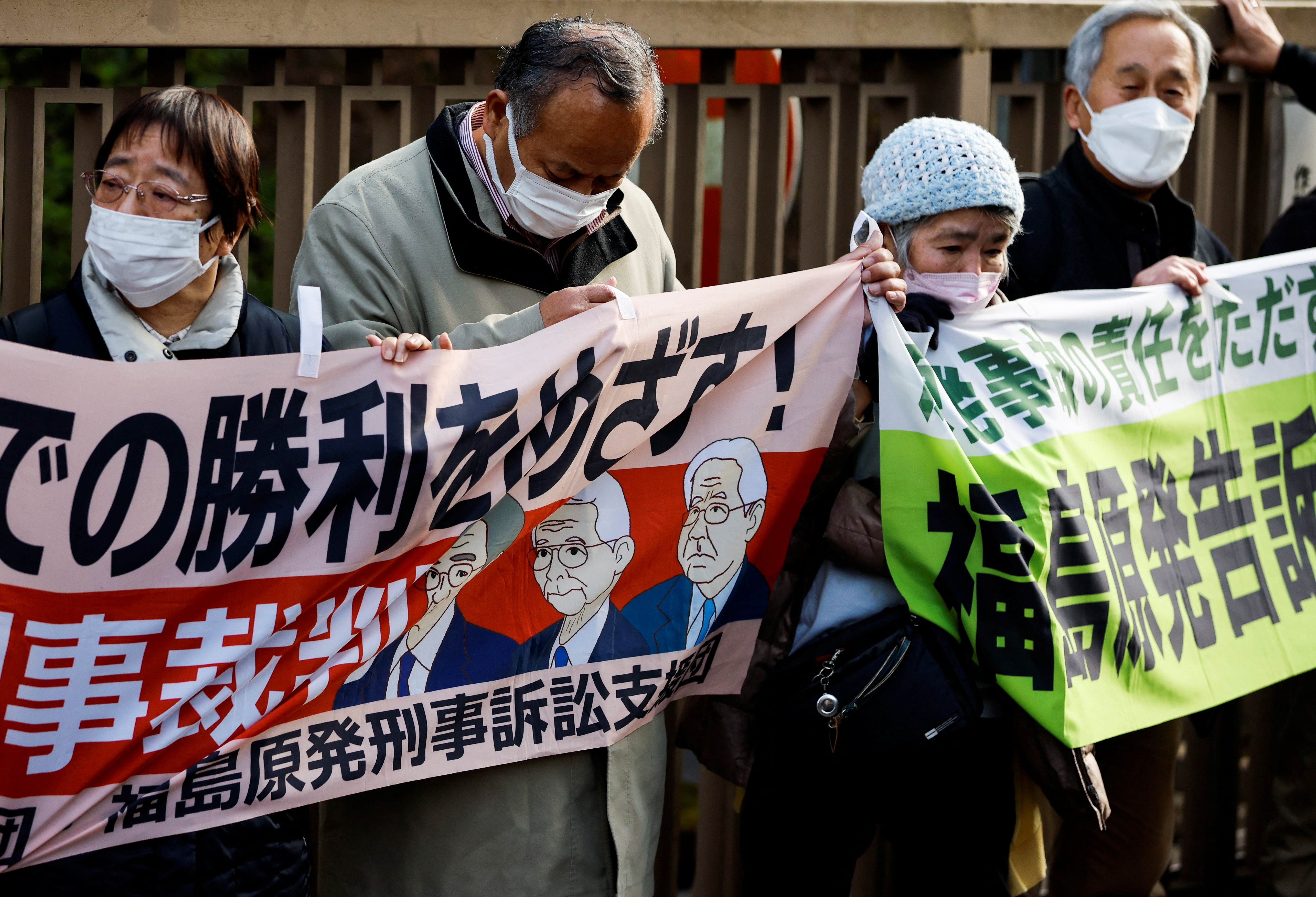 Supporters of plaintiffs hold banners after the the Tokyo High Court upheld a not guilty verdict for former Tokyo Electric Power Company executives over the 2011 Fukushima nuclear power station disaster, in Tokyo, Japan, on January 18, 2023