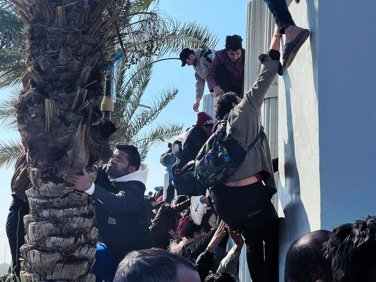 Soccer fans attempt to enter the Basra International Stadium