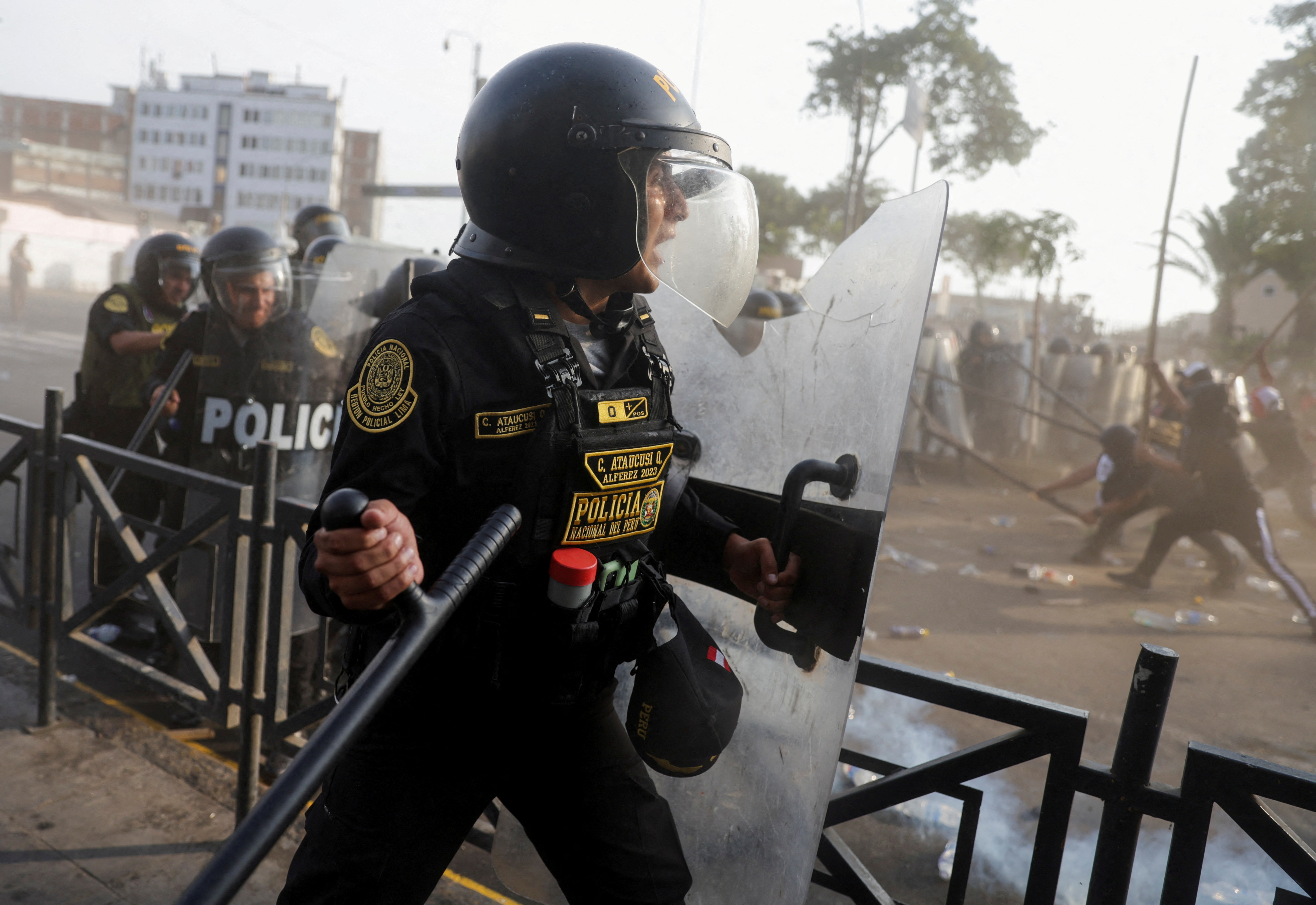 Protesters clash with riot police officers during the "Take over Lima" march to demonstrate against Peru's President Dina Boluarte