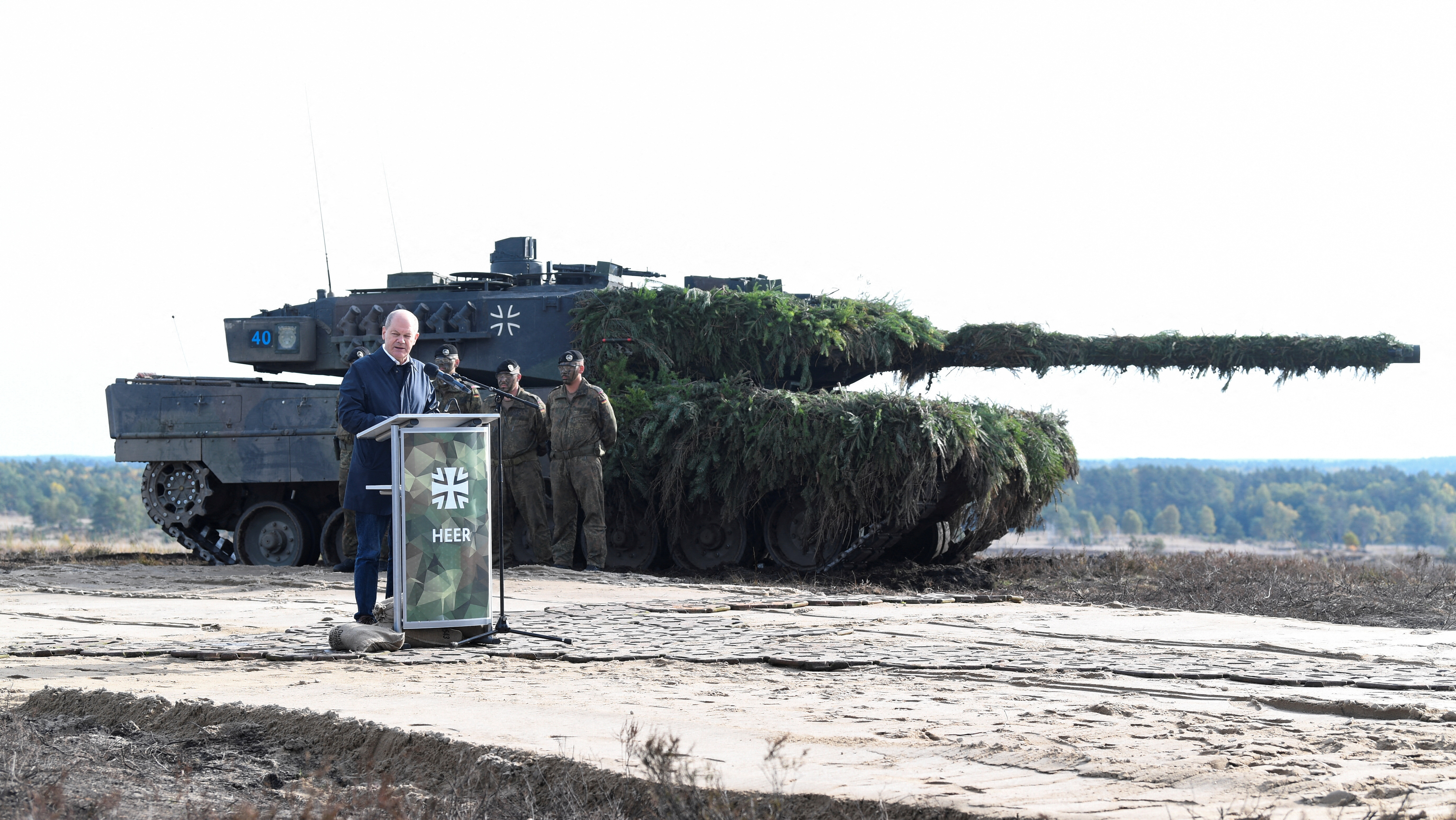 German Chancellor Olaf Scholz delivers a speech in front of a Leopard 2 tank on October 17, 2022