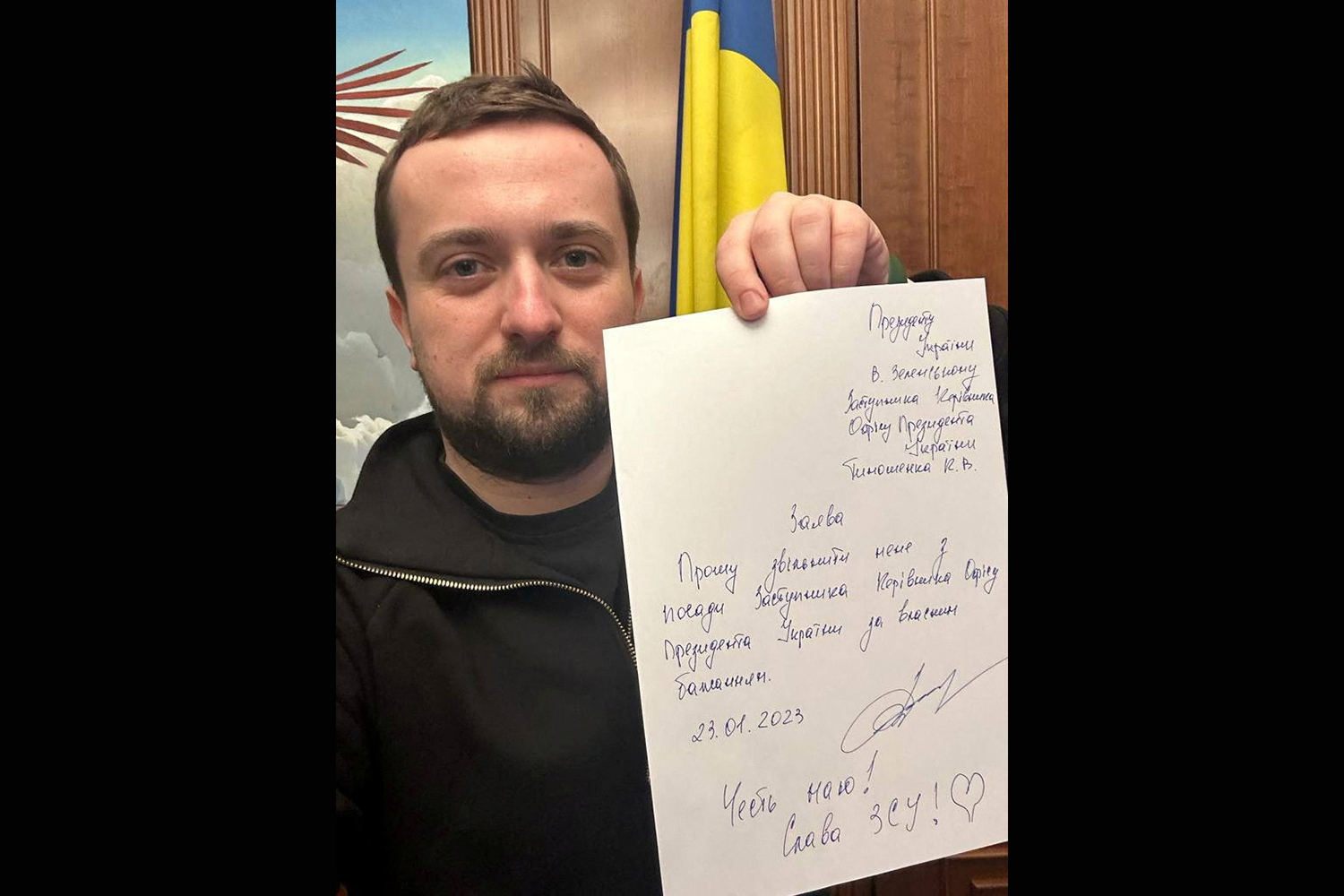 Kyrylo Tymoshenko holds up a note written on a sheet of paper as he tenders his resignation, asking President Volodymyr Zelenskyy to relieve him of his duties [Kyrylo Tymoshenko via Telegram/via Reuters]