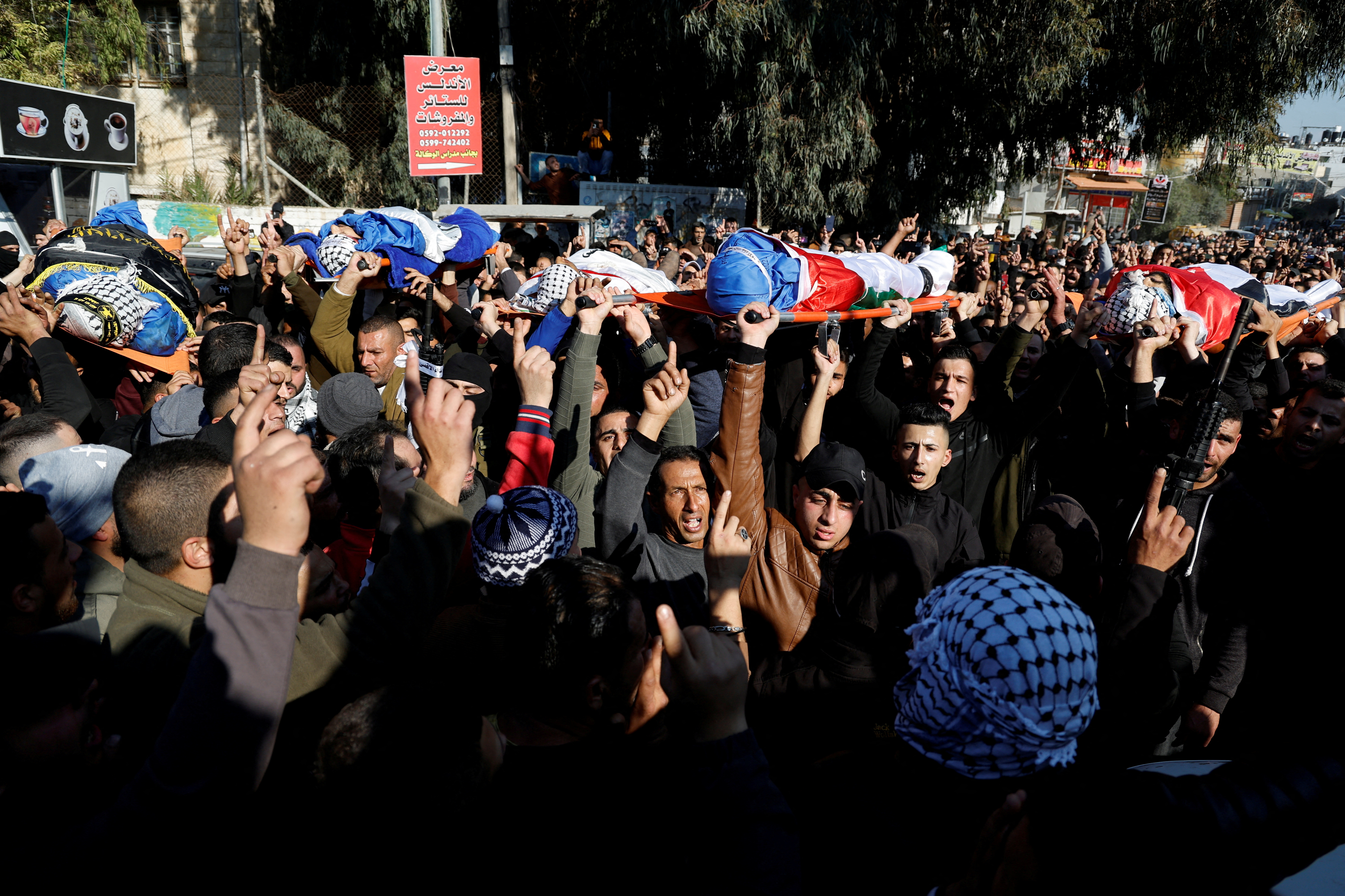 SENSITIVE MATERIAL. THIS IMAGE MAY OFFEND OR DISTURB Mourners carry the bodies of Palestinians, including militants, who were killed in an Israeli raid, during their funeral in Jenin in the Israeli-occupied West Bank January 26, 2023. REUTERS/Raneen Sawafta 