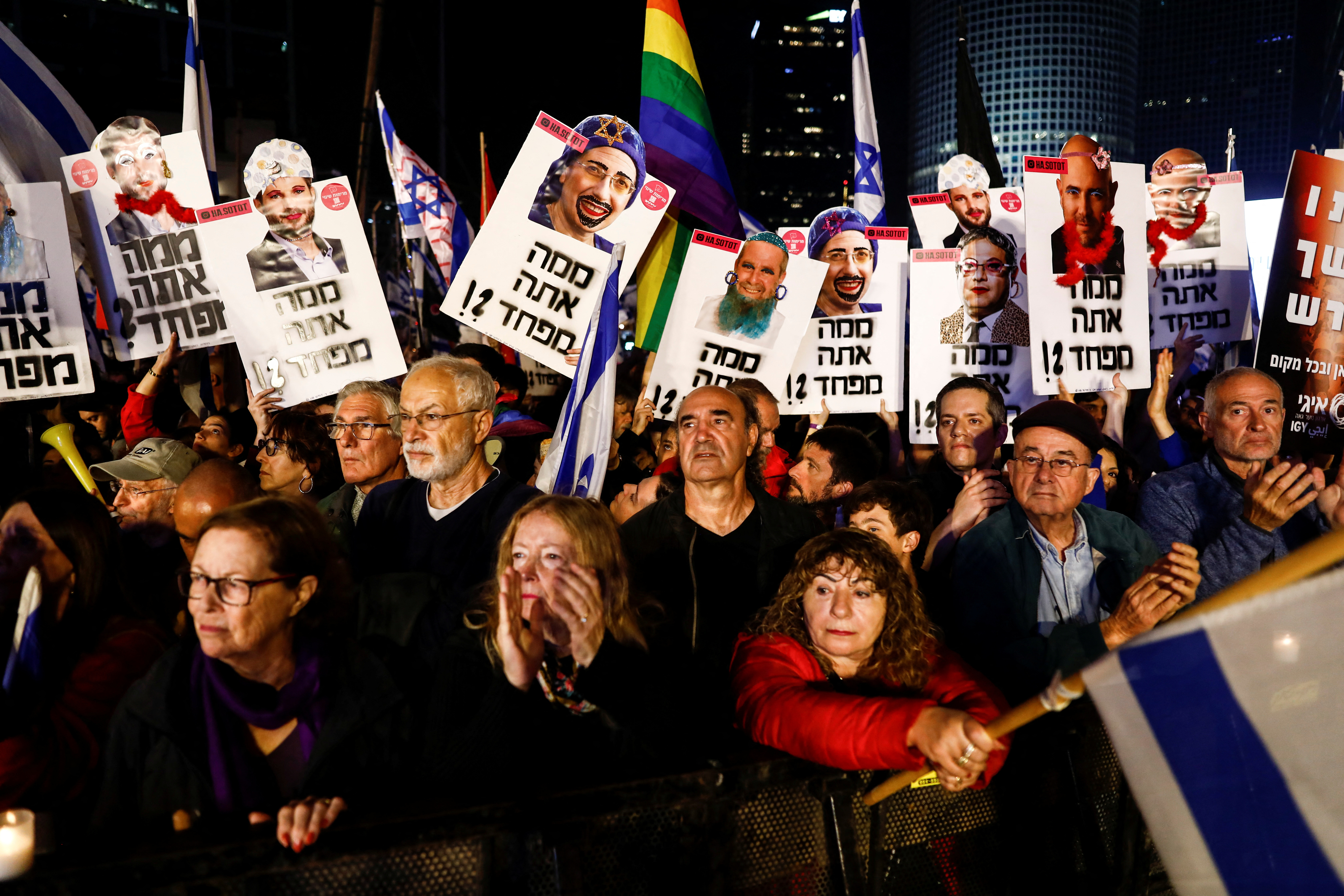 Israelis hold signs with the faces of politicians and the slogan "What are you afraid of?" during a demonstration against proposed judicial reforms by Israel's new right-wing government in Tel Aviv, Israel January 28, 2023. REUTERS/Corinna Kern