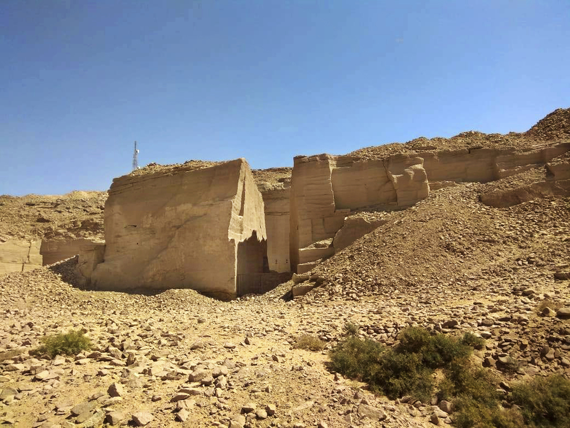 A photo of a quarry in Aswan set against a blue sky