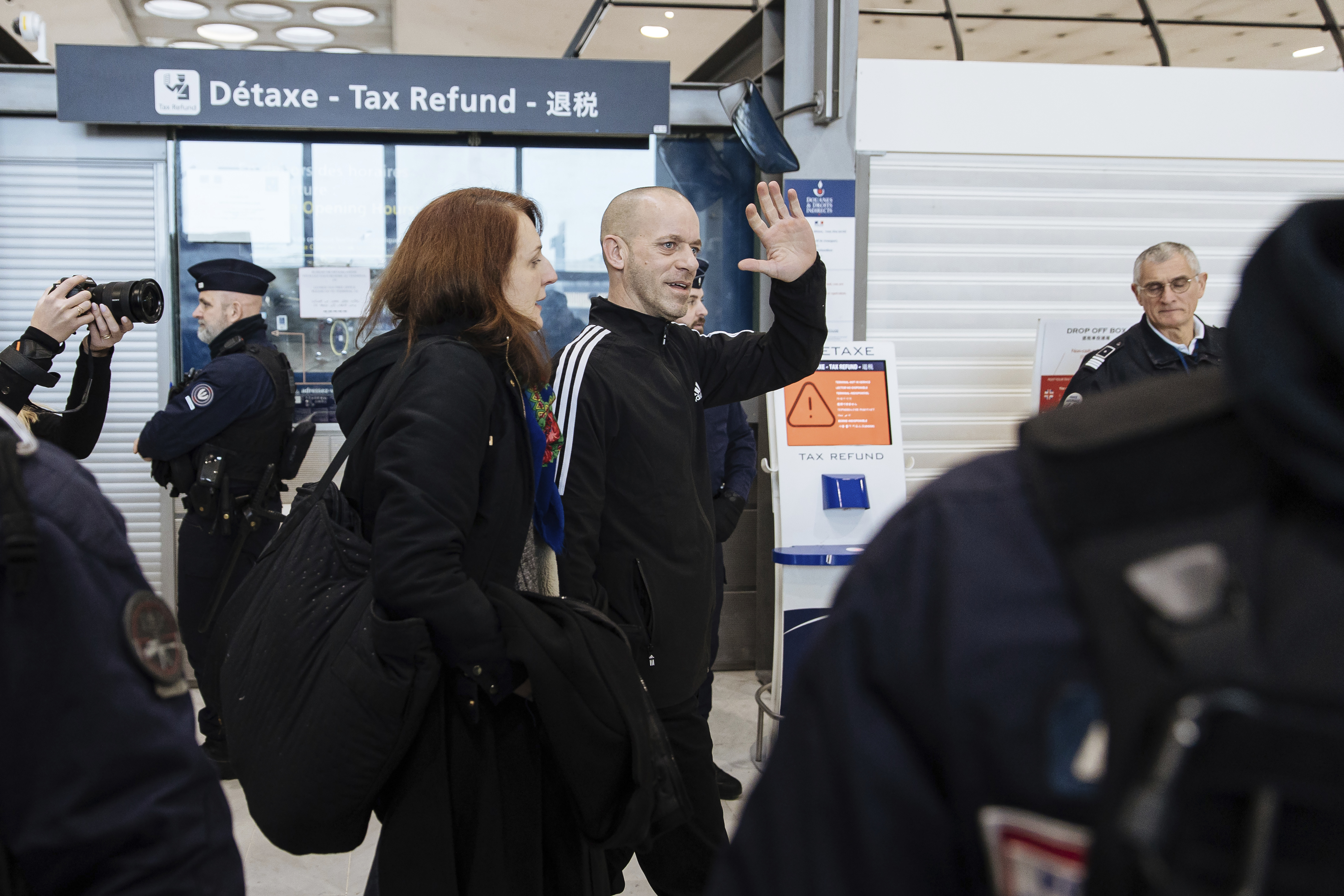 Palestinian French lawyer and activist Salah Hammouri walks with his wife Elsa Lefort as he arrives at the Charles de Gaulle Airport